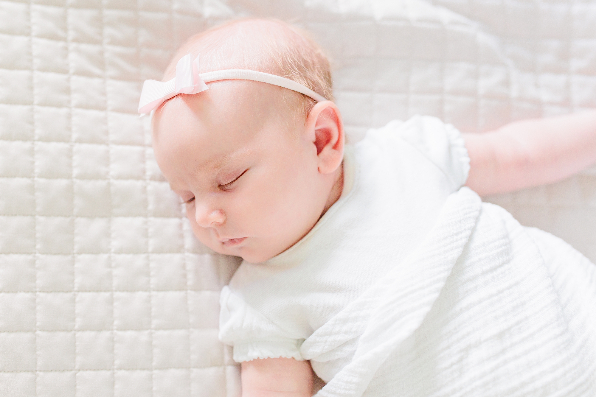 baby girl sleeps on quilt during lifestyle newborn photos