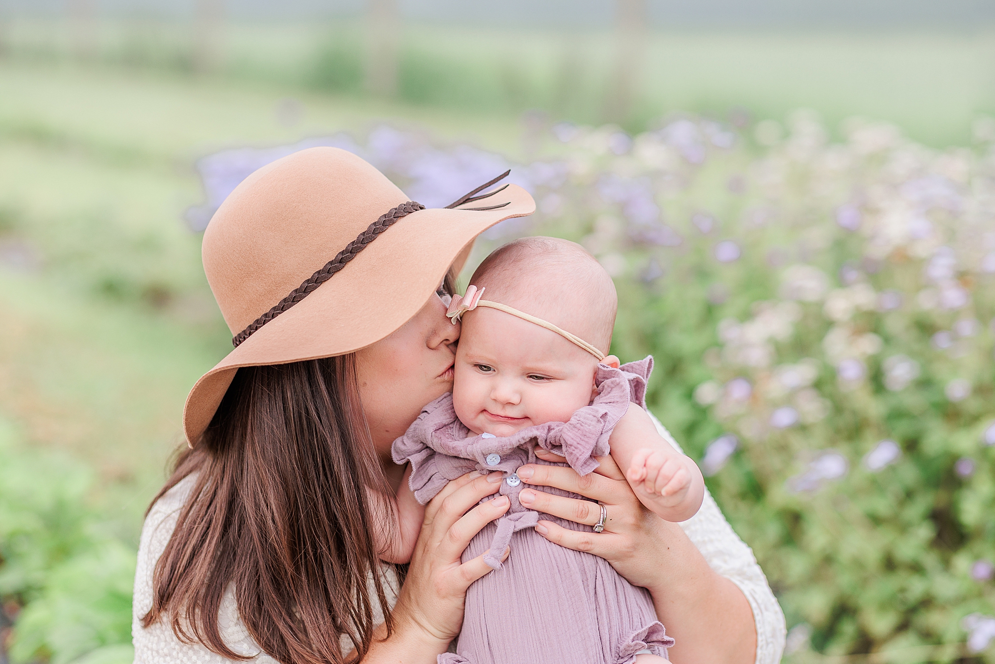mom kisses baby girl during Castle Bridge Farm mommy & me portraits
