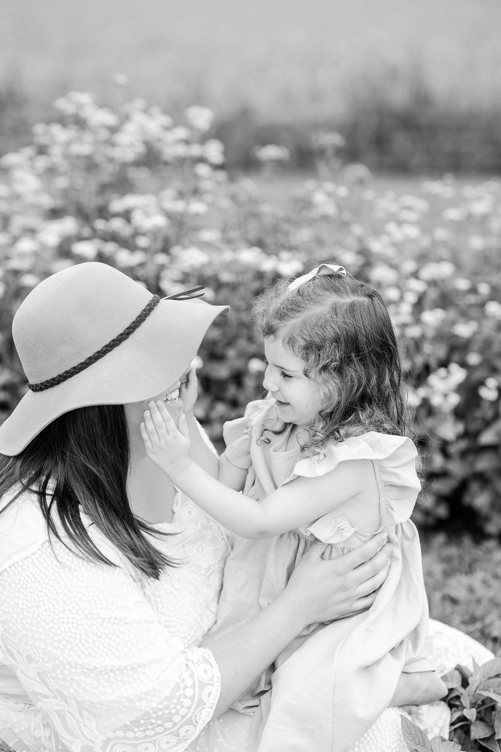 toddler holds mom's face during portraits at Castle Bridge Farm