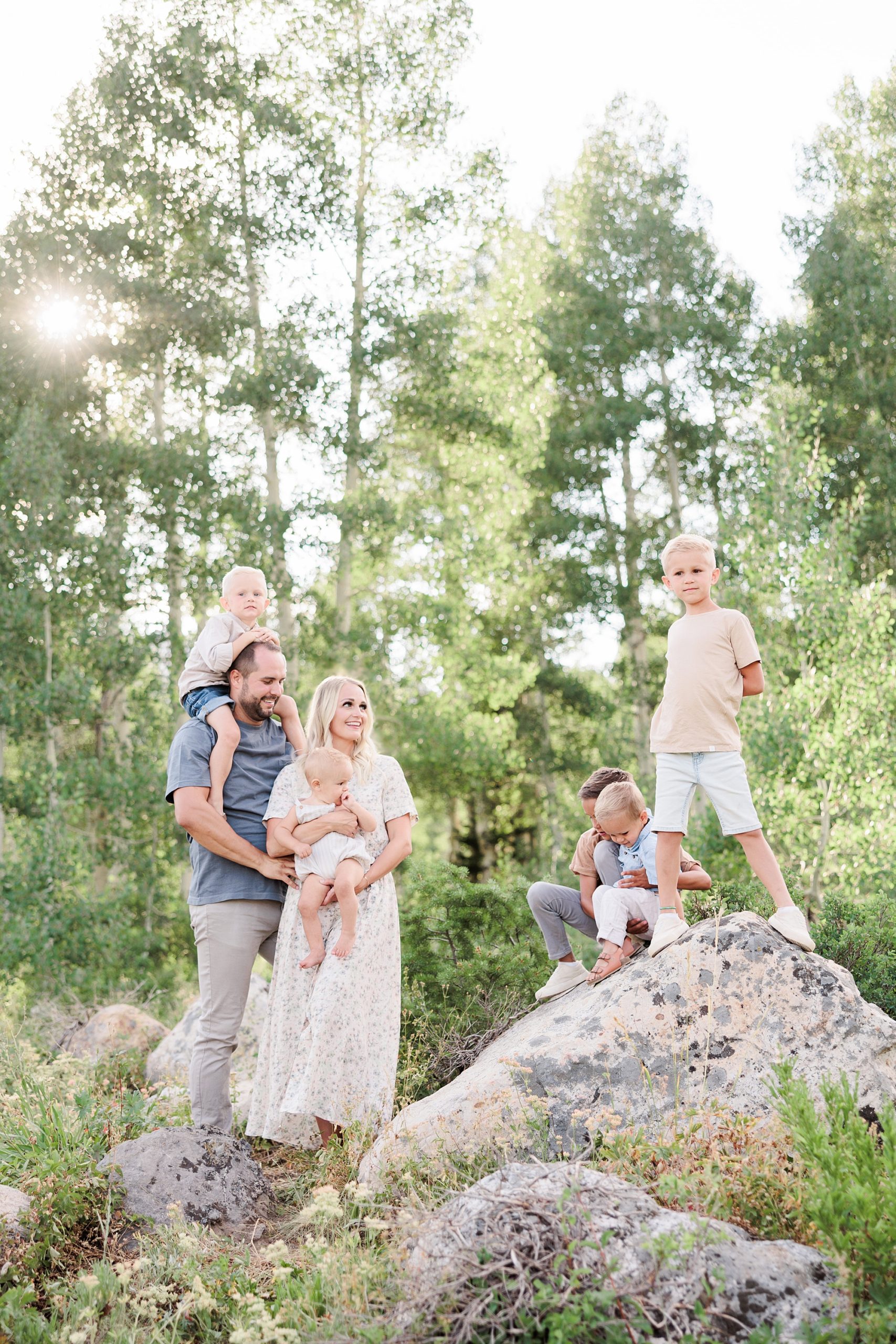 parents play with kids during family photos in Utah woods