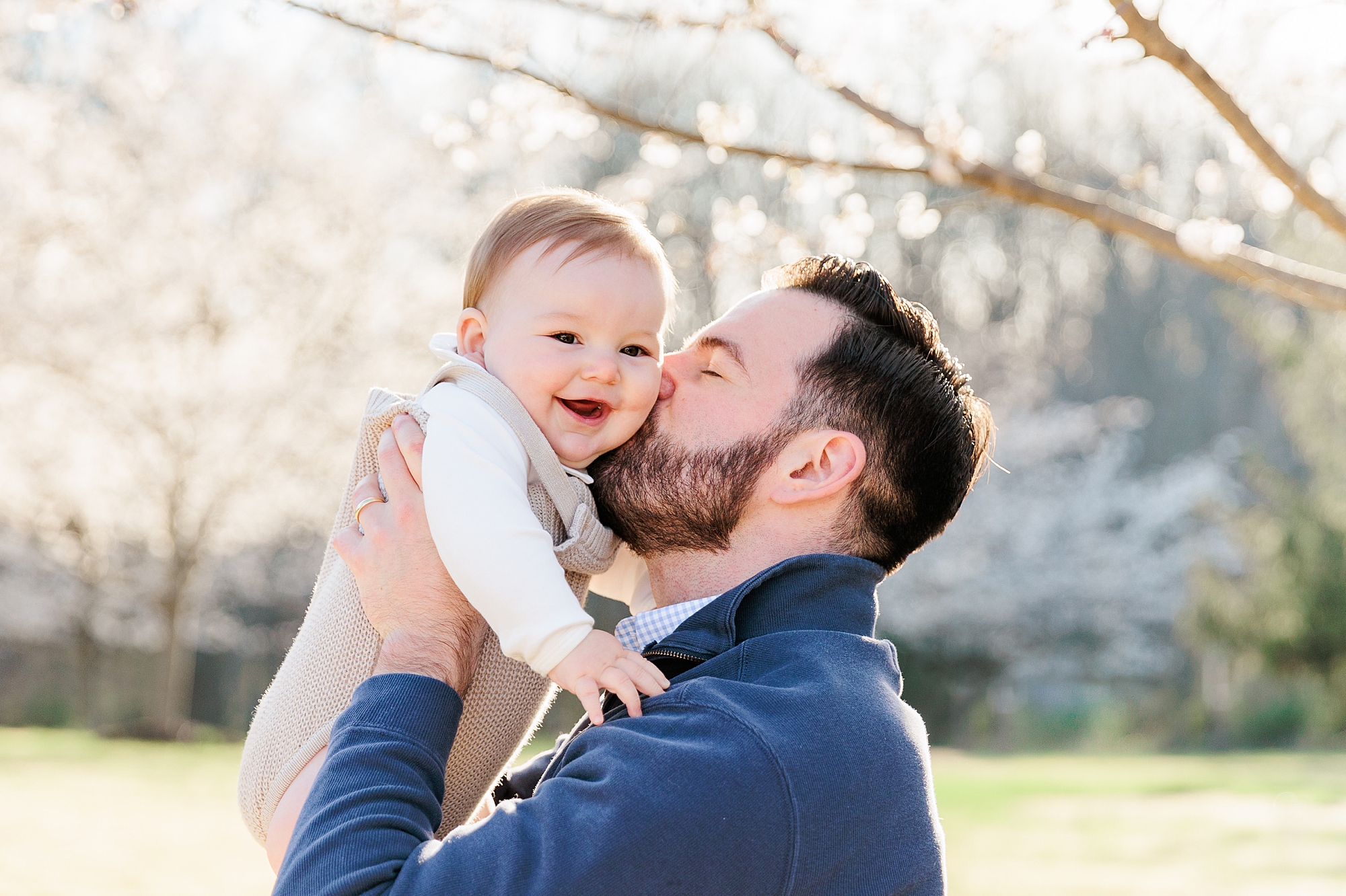 dad kisses baby's cheek during MD milestone portraits