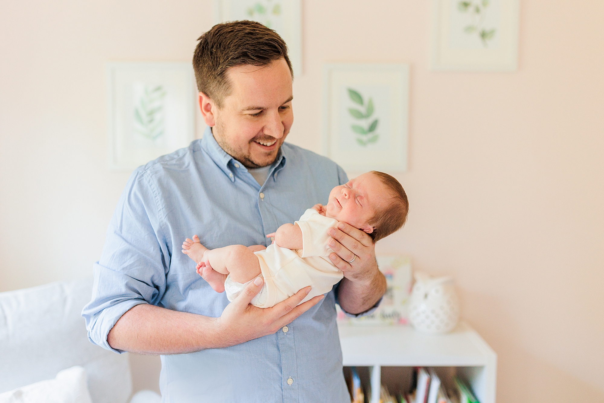 dad holds new baby girl during lifestyle newborn session