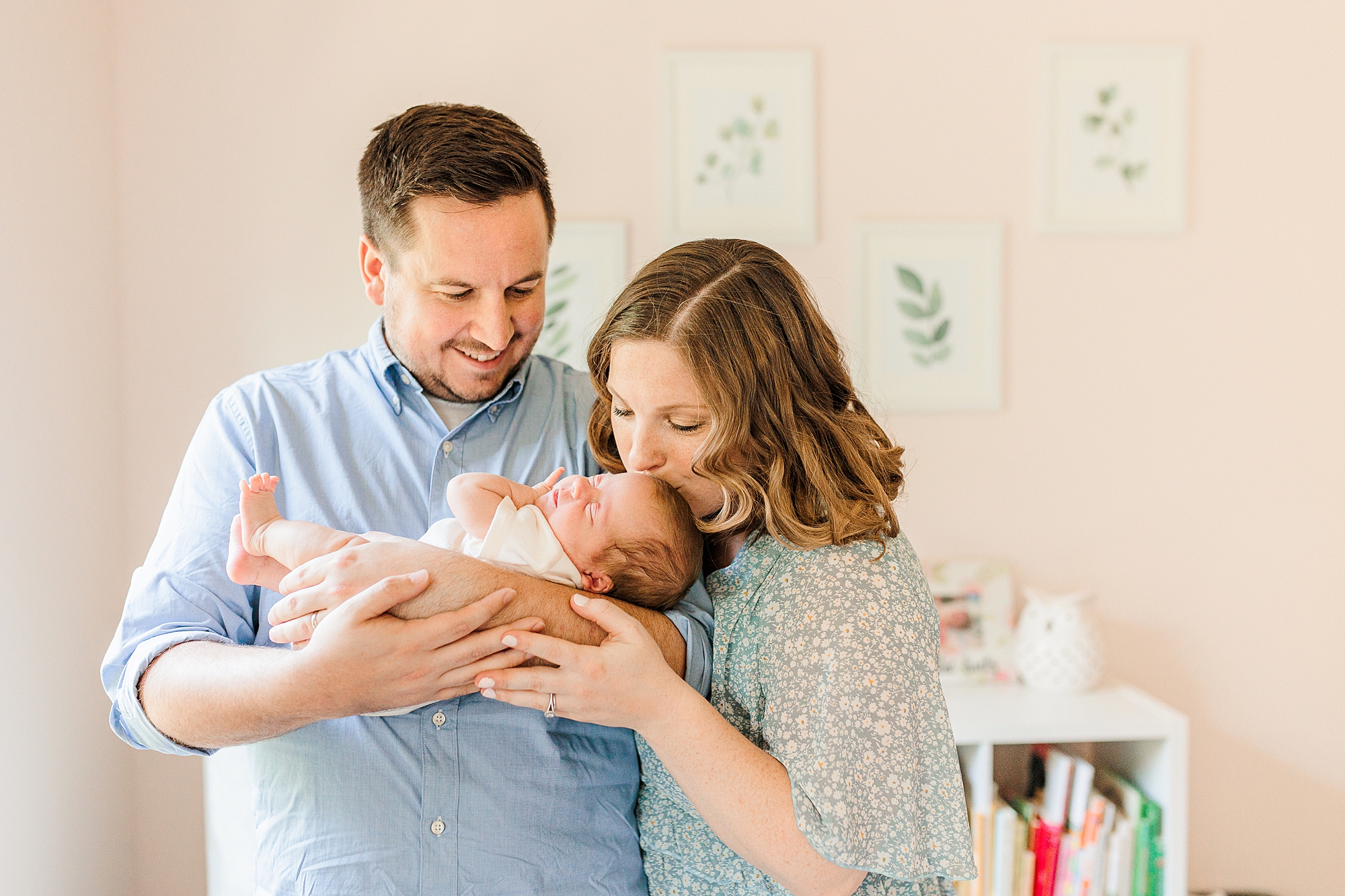 new parents look down at baby girl in Anne Arundel Co. nursery during lifestyle newborn session