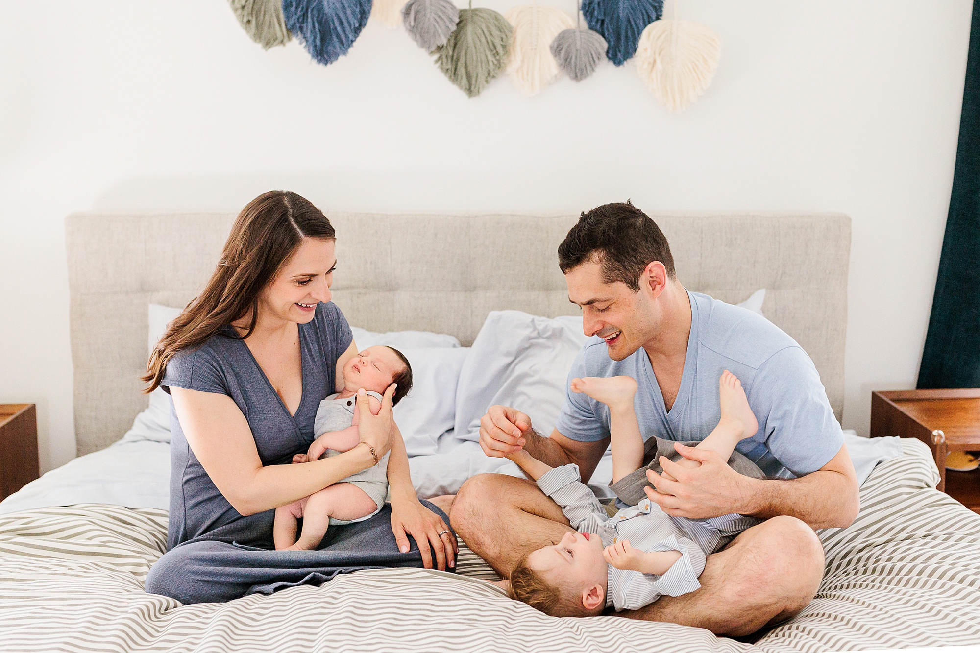 new parents sit with baby girl and son during Clarksville MD lifestyle newborn session