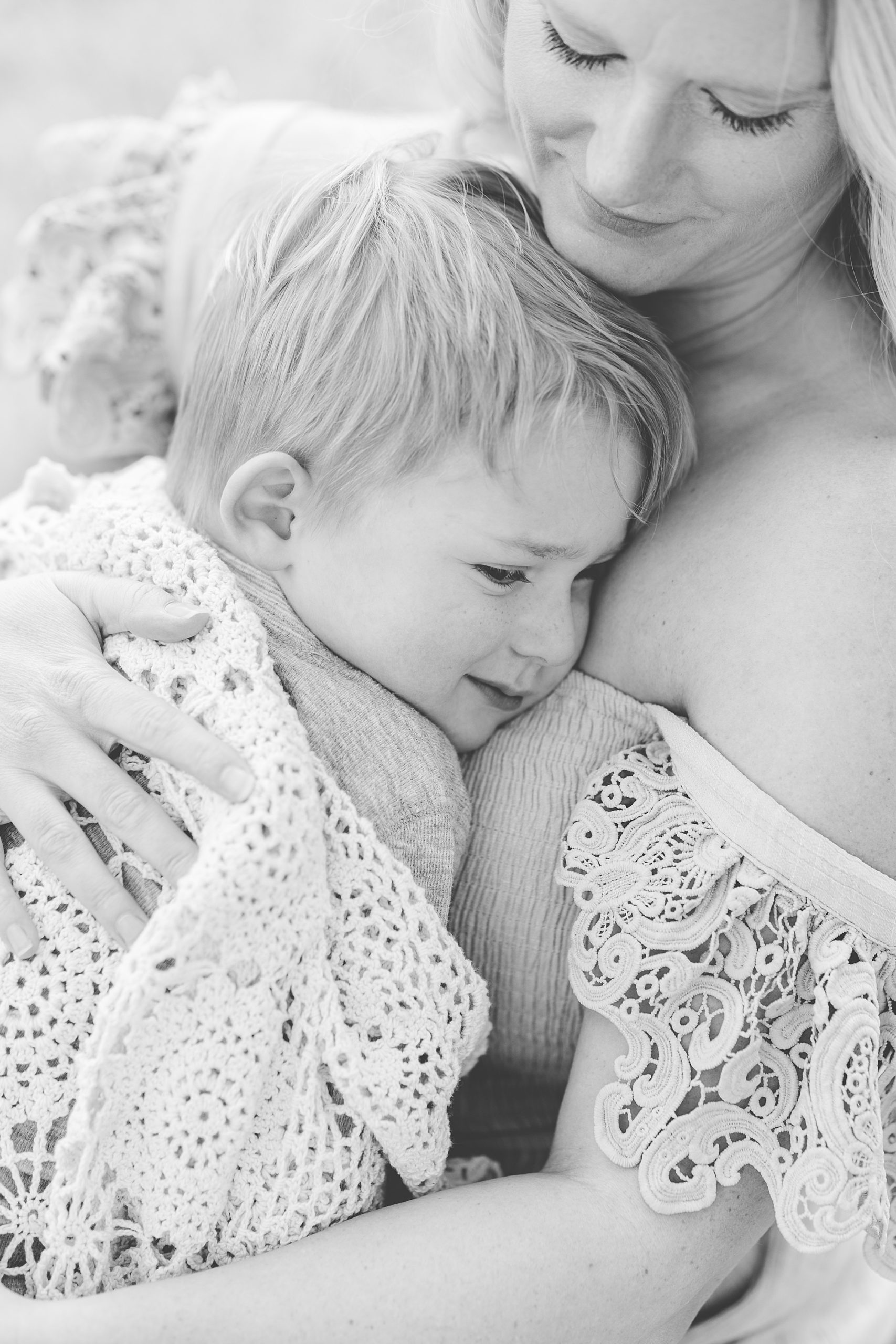 mom hugs son to chest during Howard County family portraits