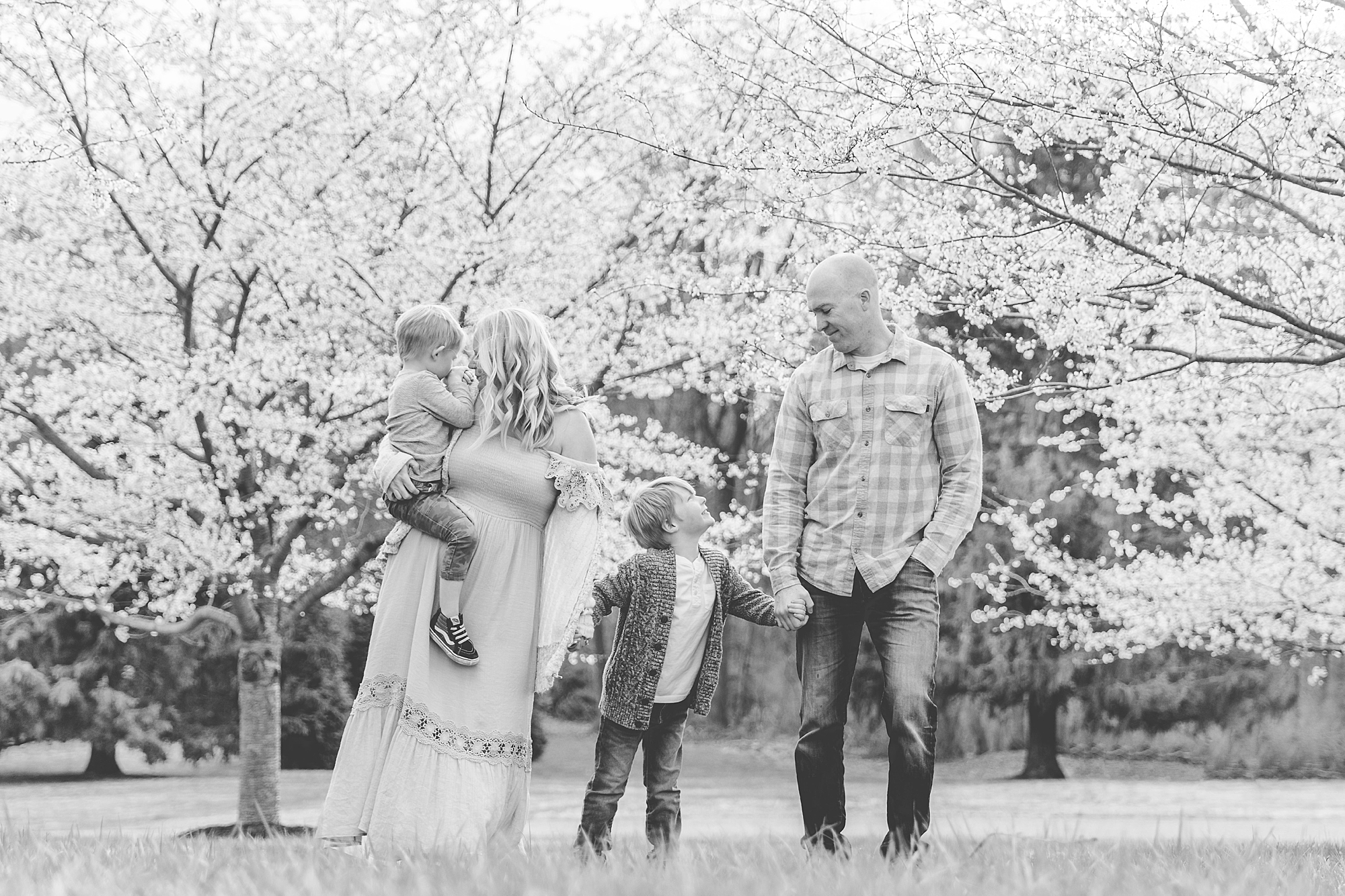 parents walk with two sons during Howard County family portraits