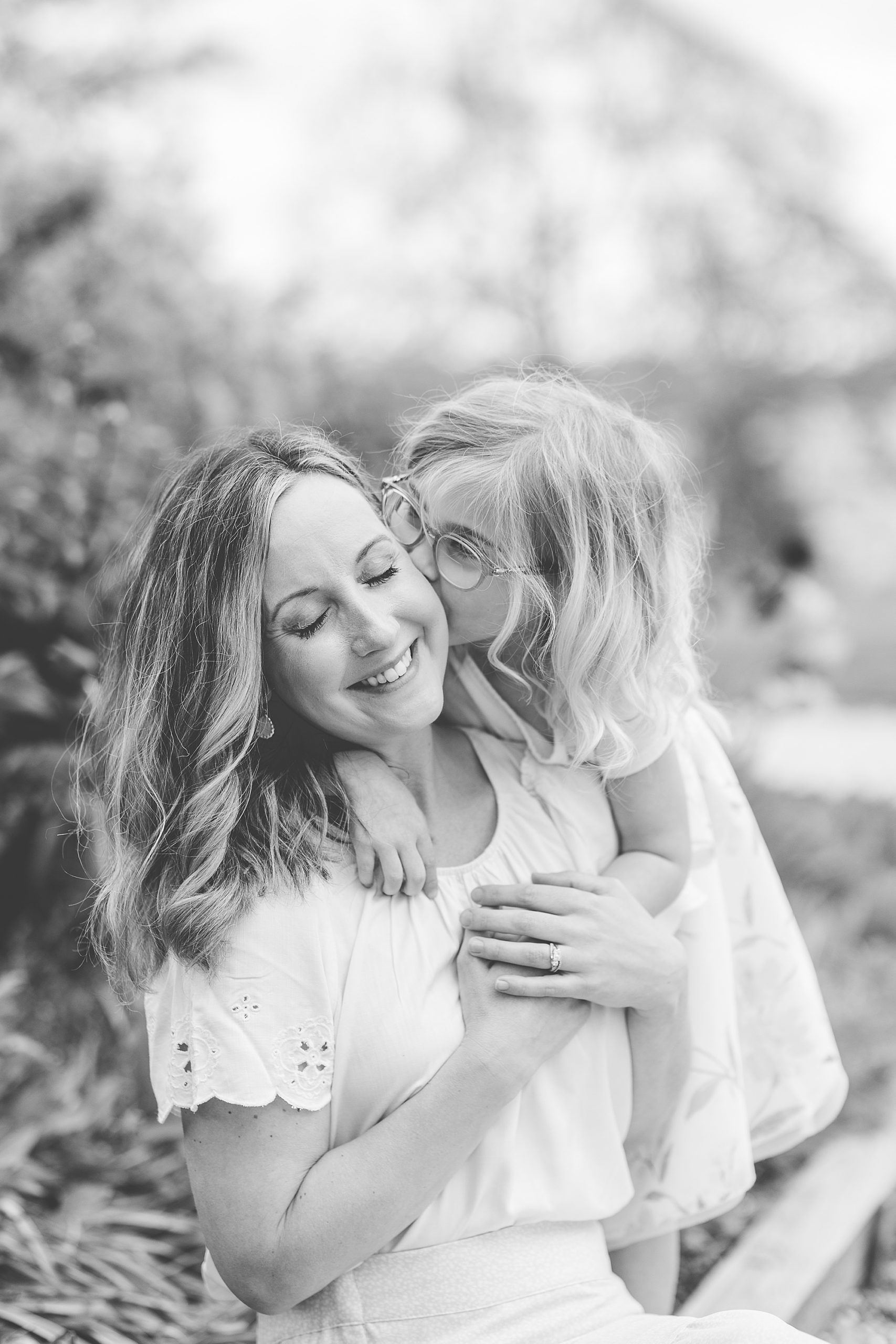 girl kisses mom's cheek during Annapolis MD family photos