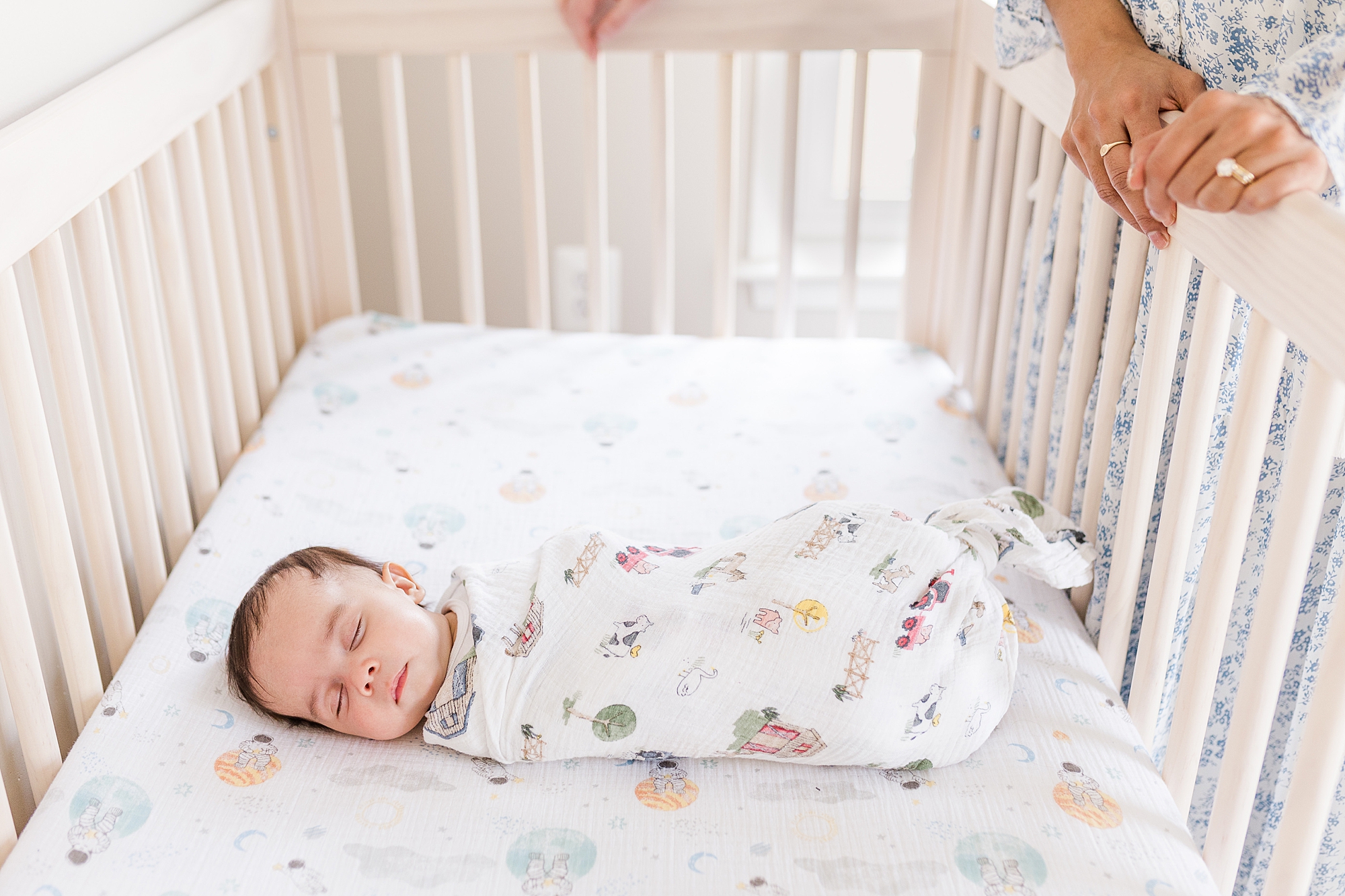 baby sleeps in crib during newborn photos at home