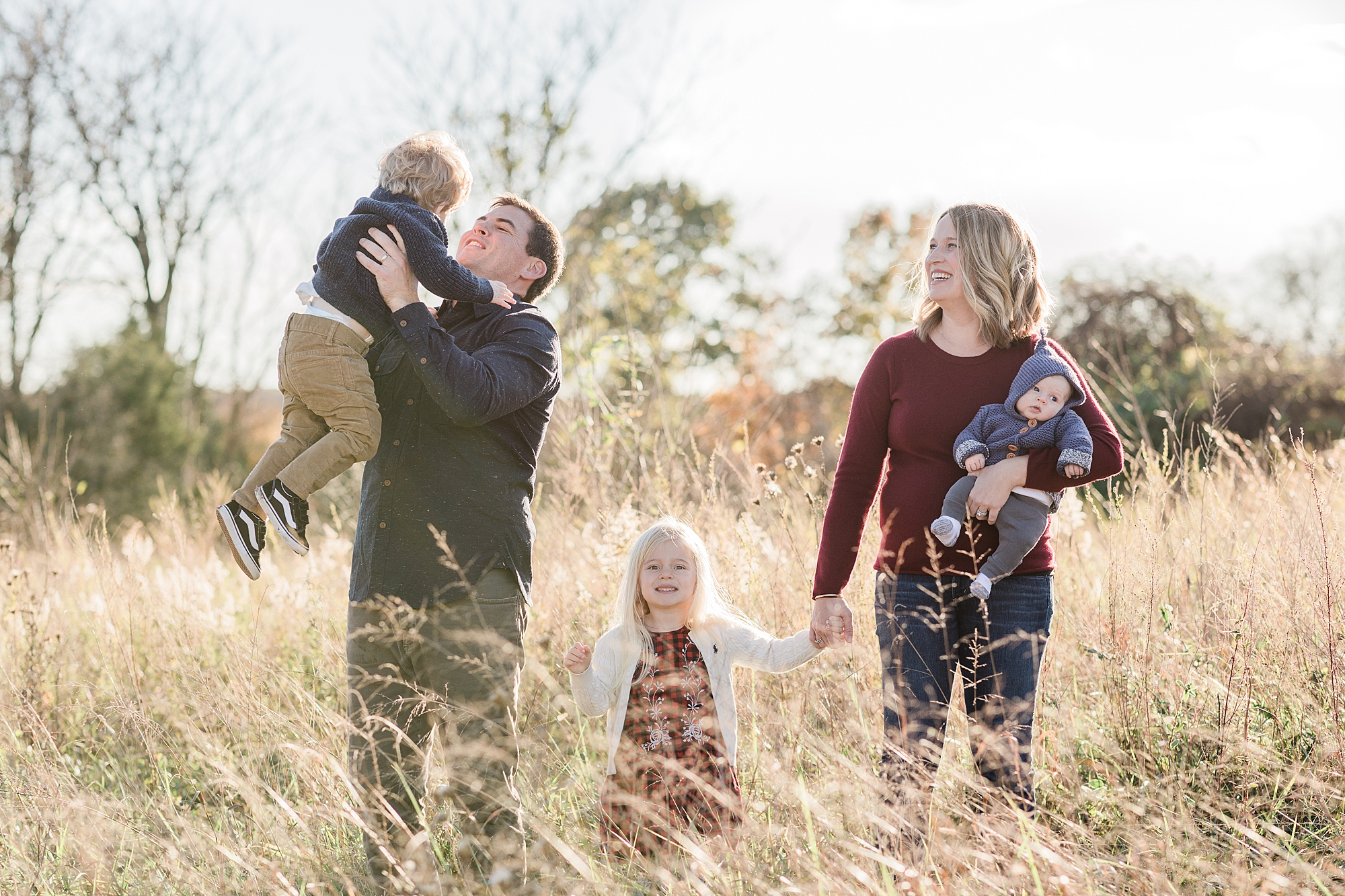 dad lifts son in the air during family photos in Leesburg VA