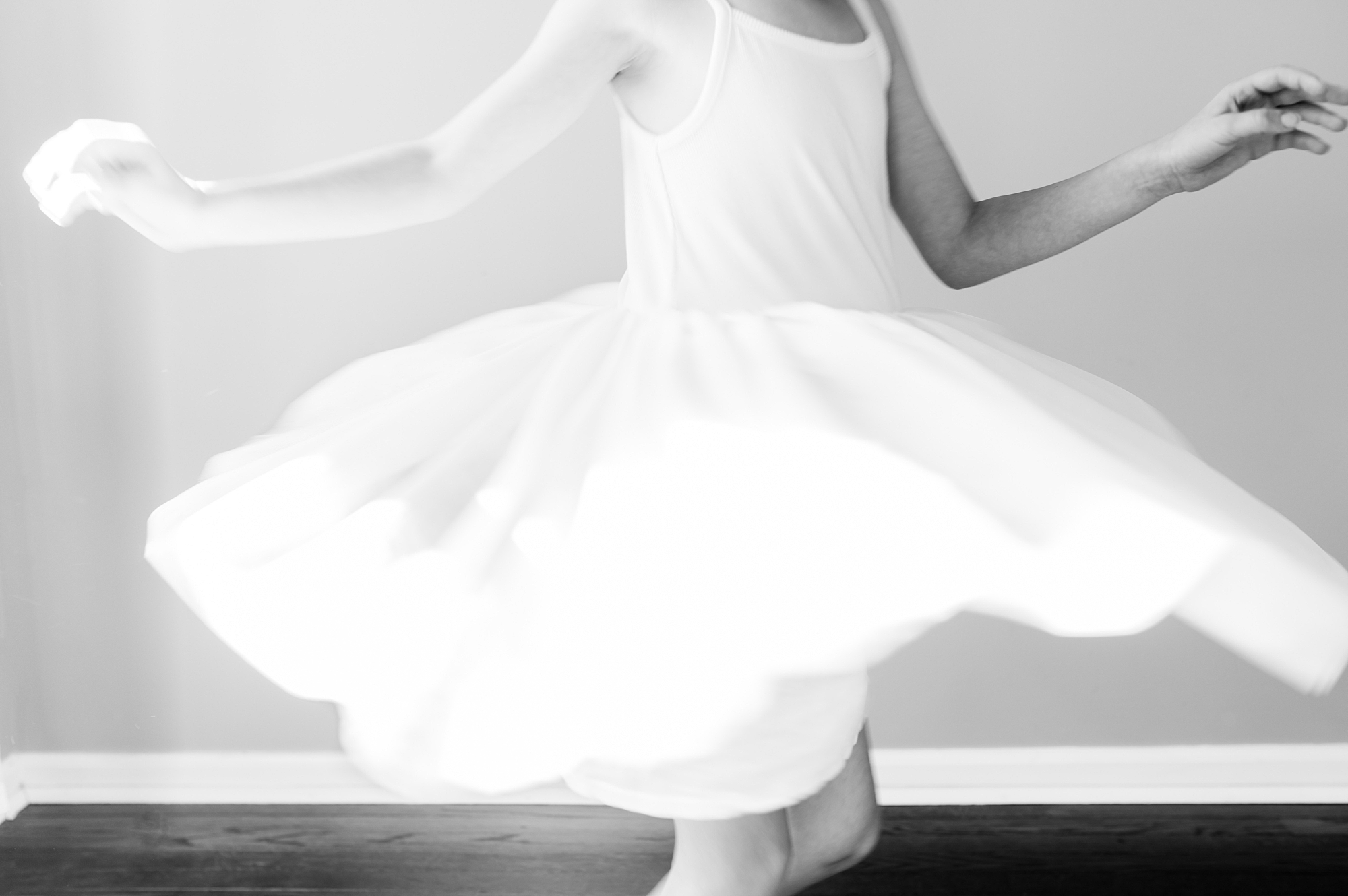 girl twirls in dress at home during lifestyle family photos 