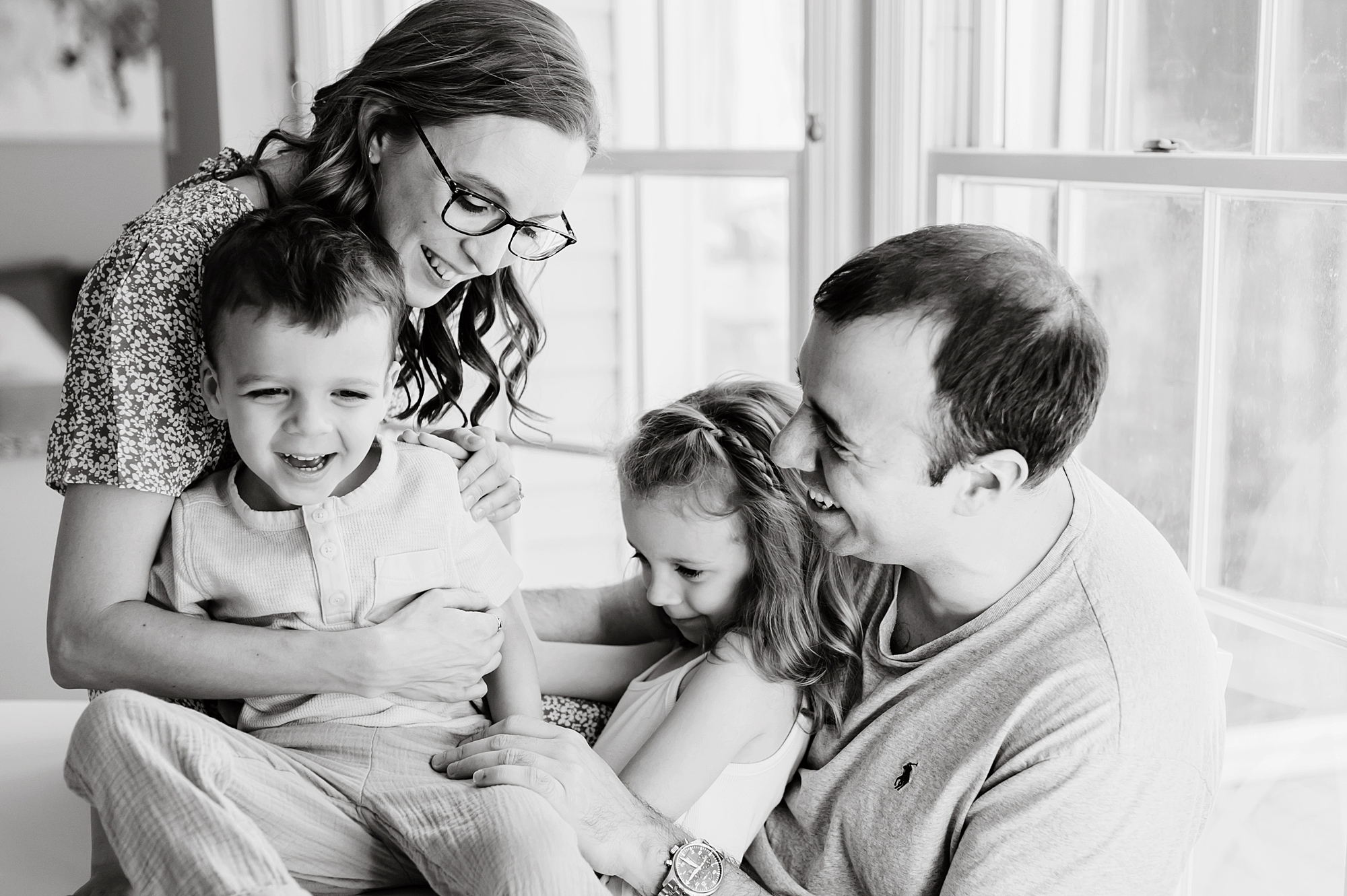 mom and dad laugh with kids during Maryland lifestyle family photos