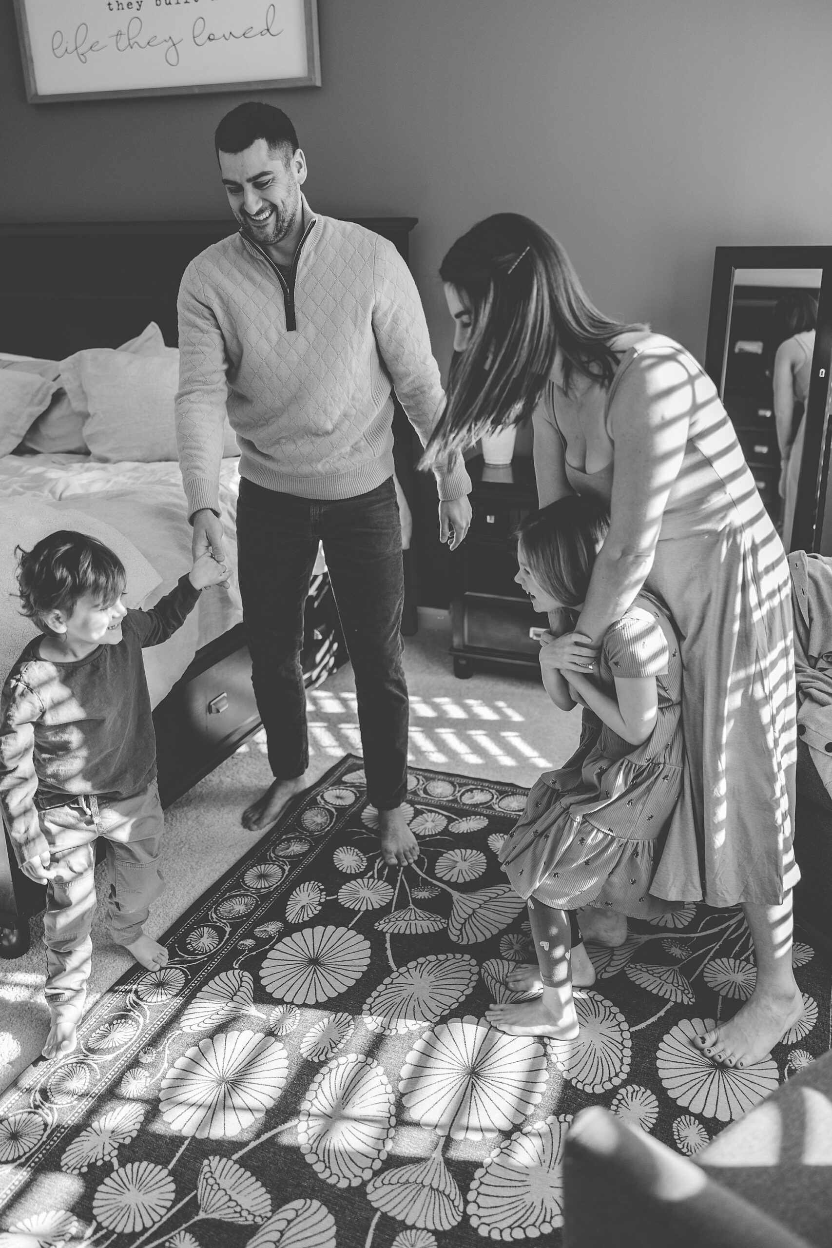 family dances in living room during Baltimore in-home family photos