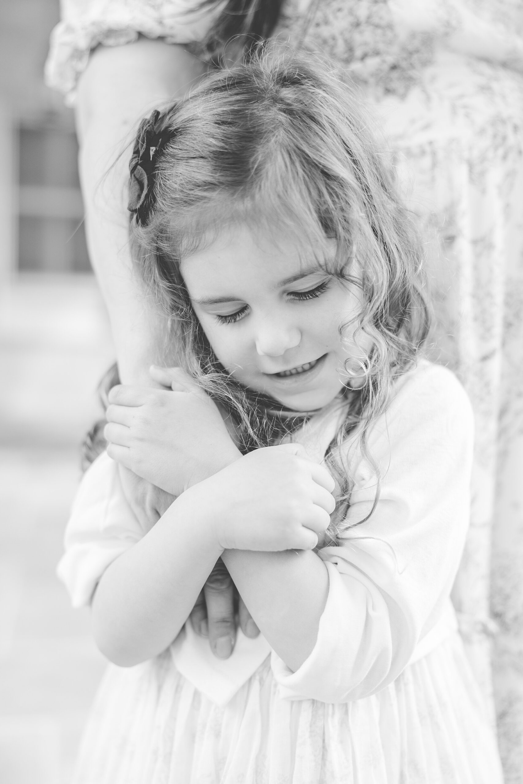 girl holds mom's hand during mommy and me photos in Maryland