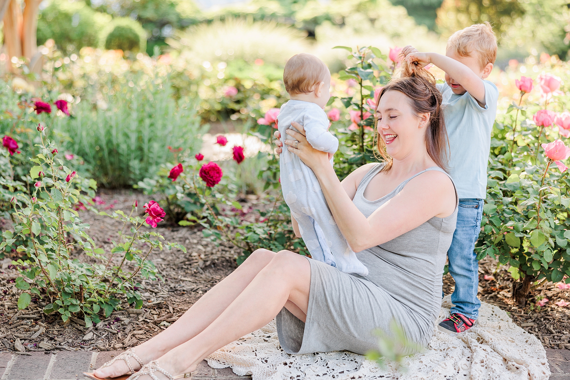 mom plays with babies during spring family photos in Maryland 