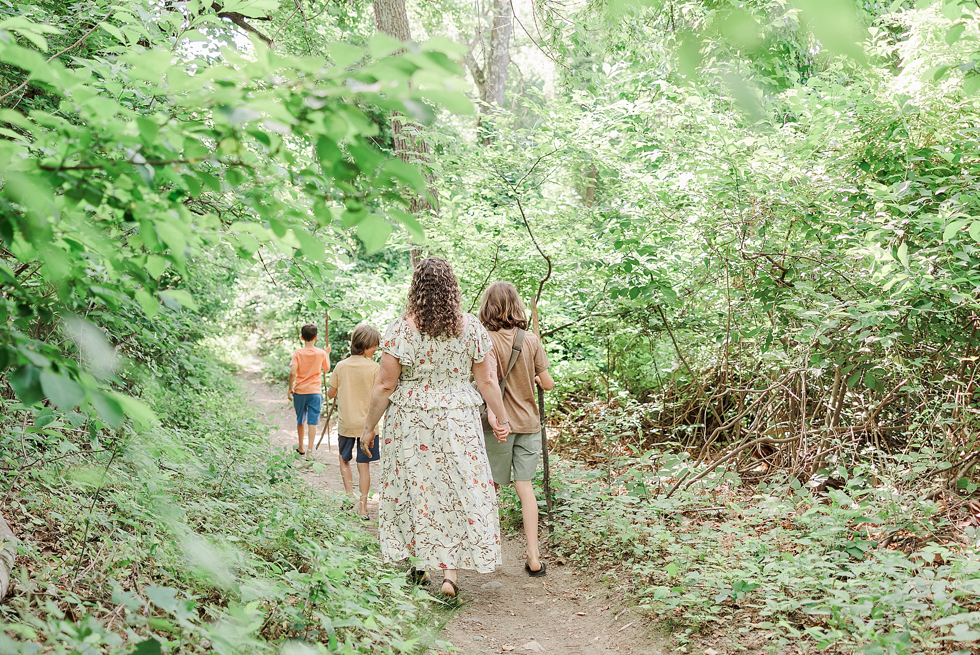 family of five walks on trail during Patapsco State Park family photos