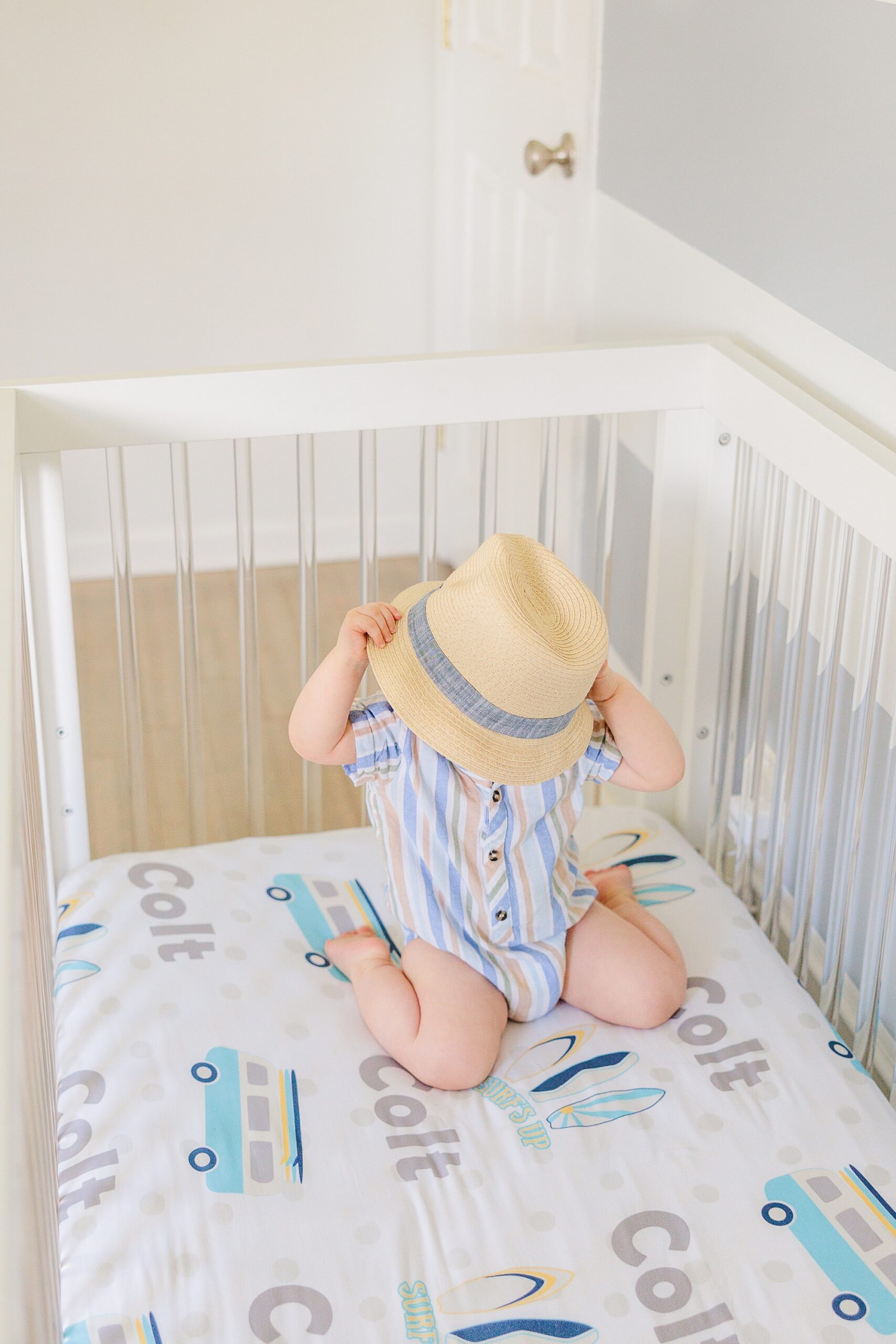 baby kids under straw hat in crib during Maryland Family Lifestyle Photos