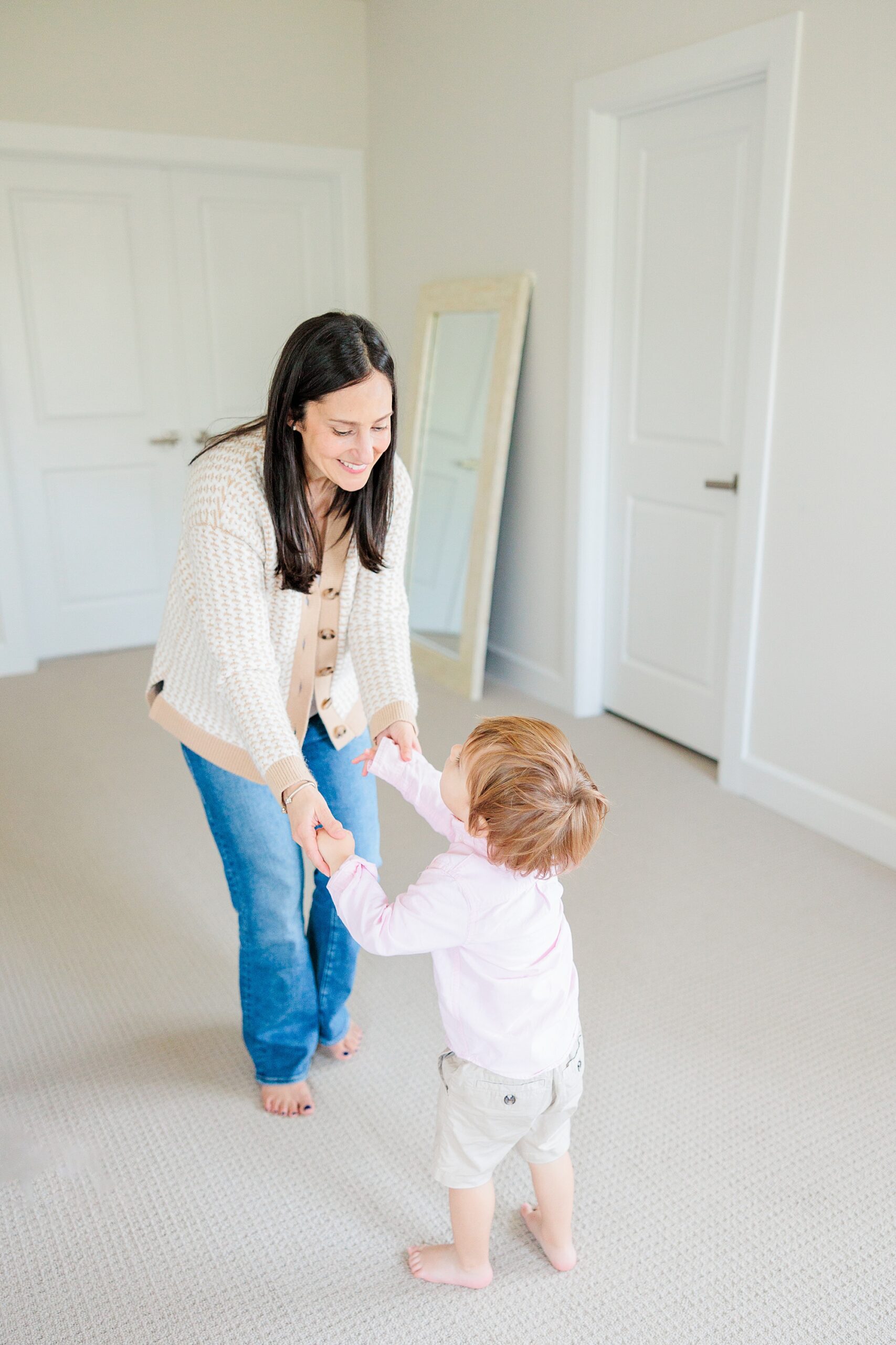 mom dances with daughter at home during lifestyle family photos in Maryland