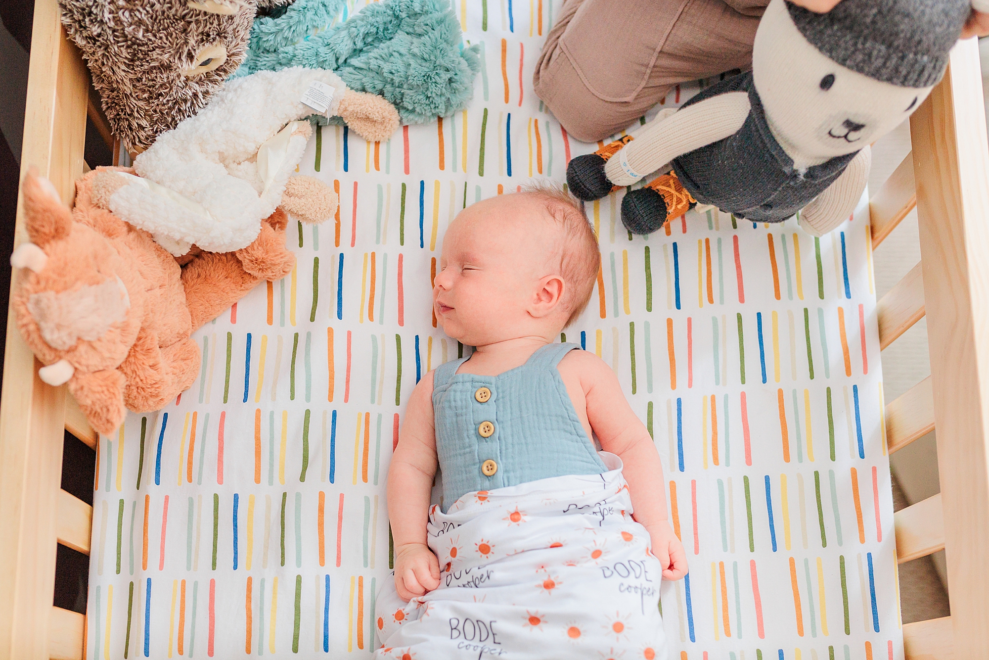 baby lays in crib during lifestyle newborn portraits 