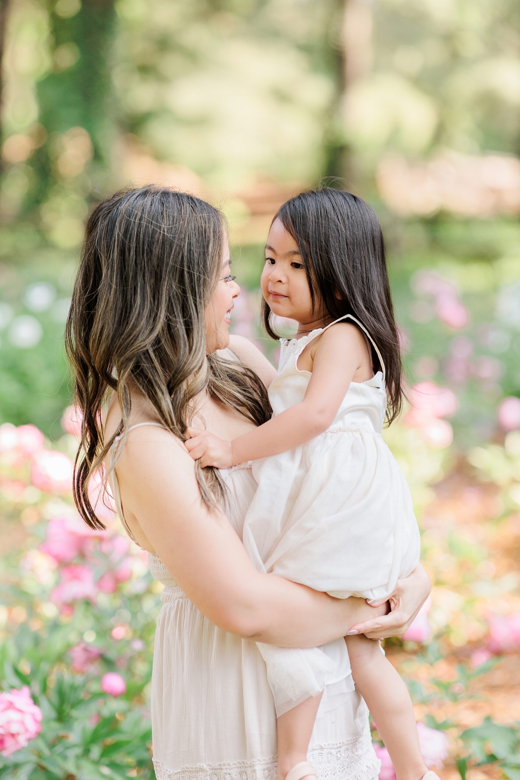 woman hugs daughter on hip during mommy & me photos in Maryland