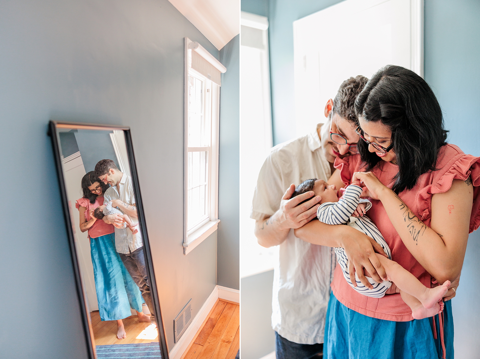 parents smile down at baby girl in reflection of mirror in home 