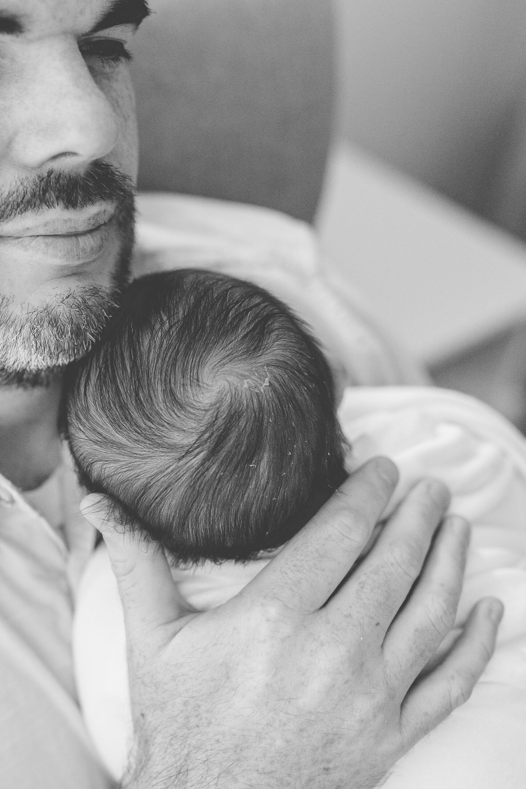 dad holds son on chest in nursery during Northern Virginia newborn session