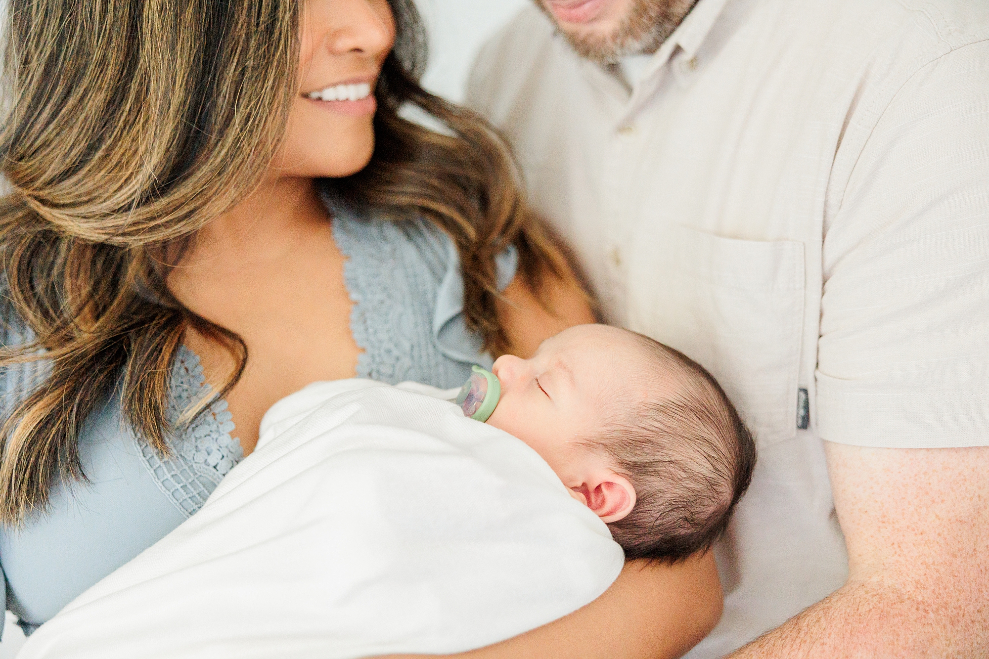 new parents hold son in arm during Northern Virginia newborn session
