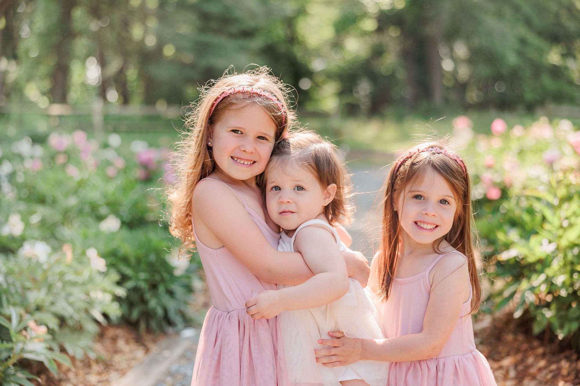 three sisters in spring dresses during peony minis during MD family photos