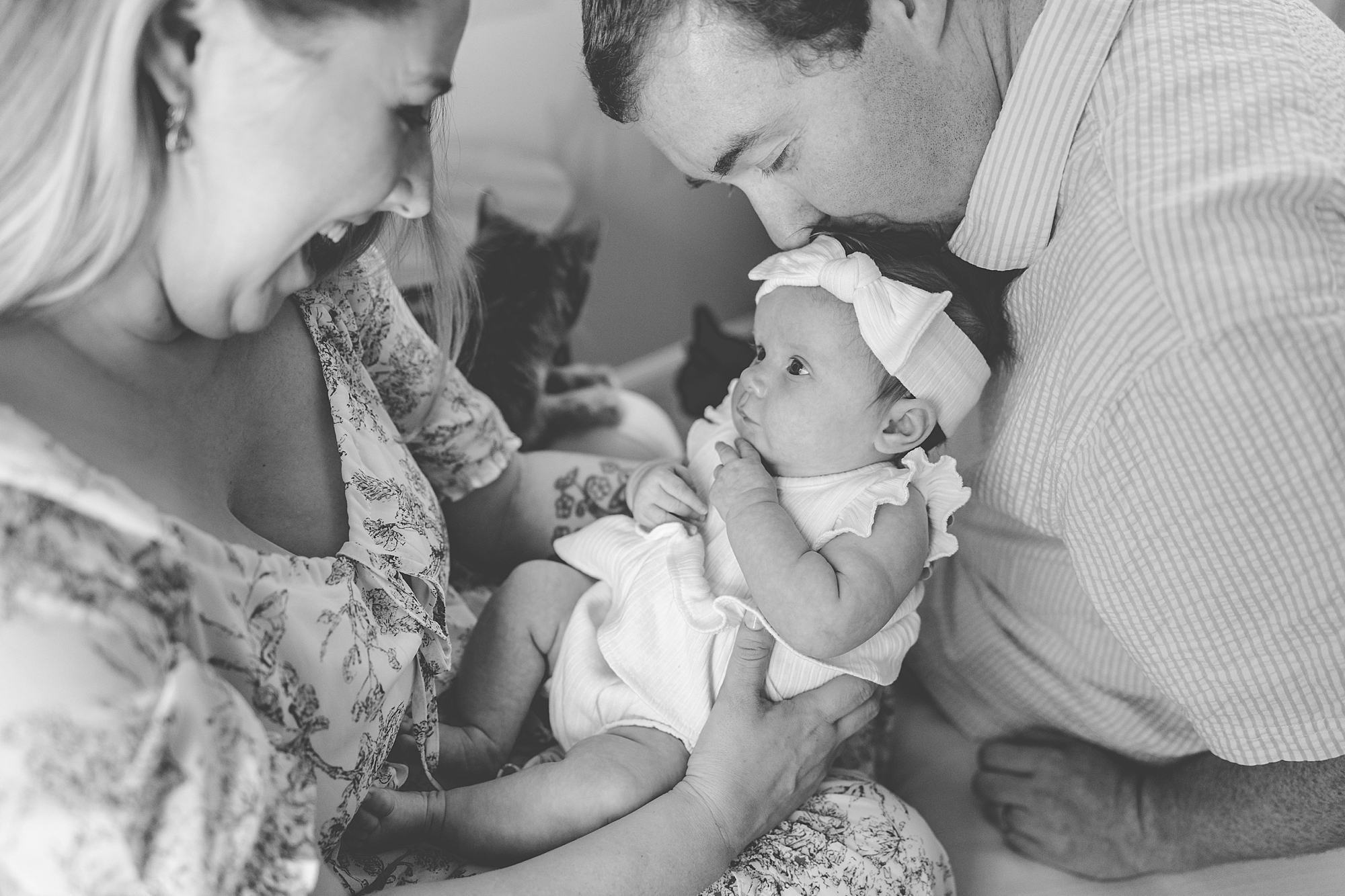 parents snuggle with newborn girl during new life session with Maryland newborn photographer Christina Tundo Photography