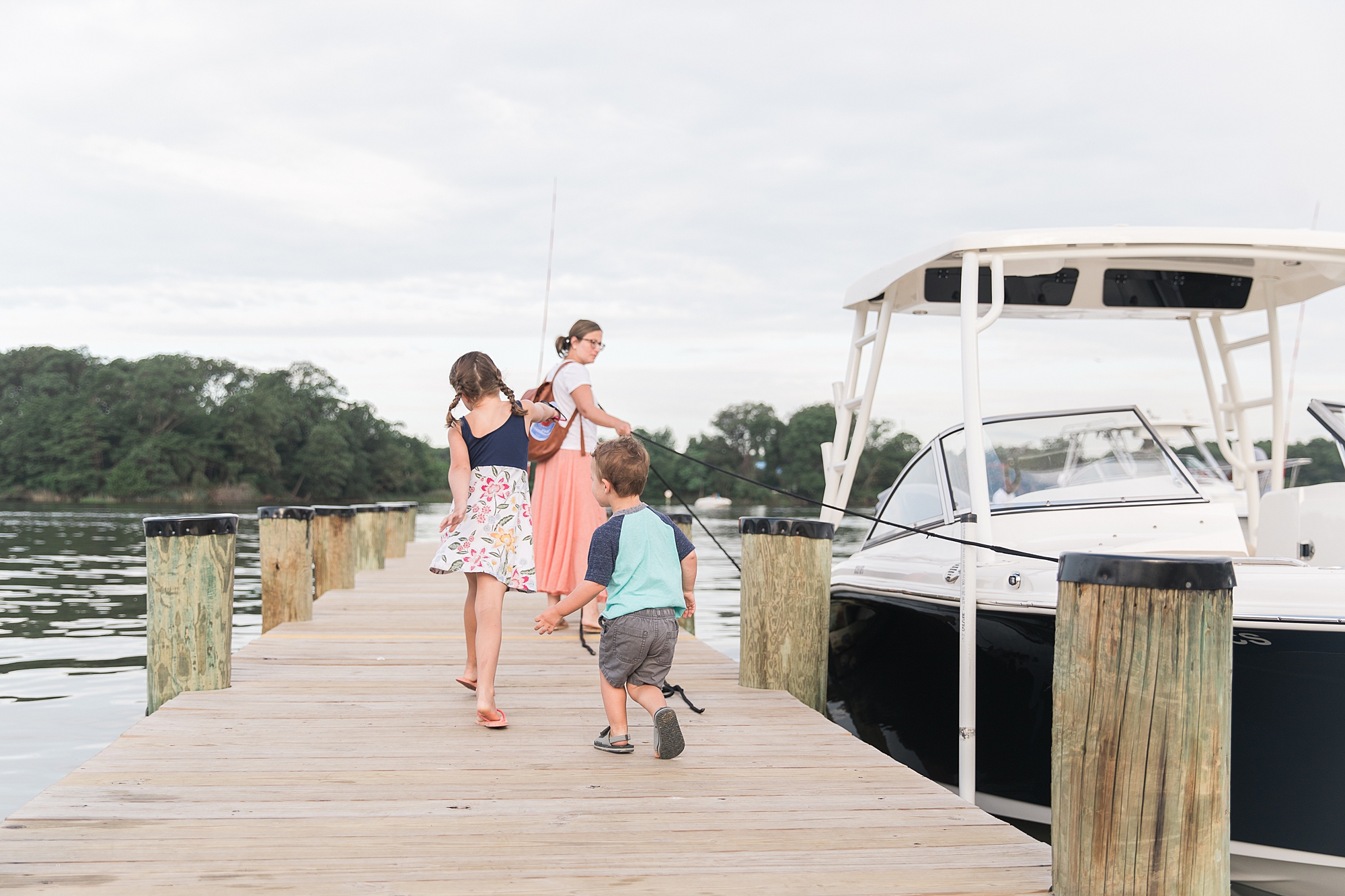 family walks down dock in Maryland 