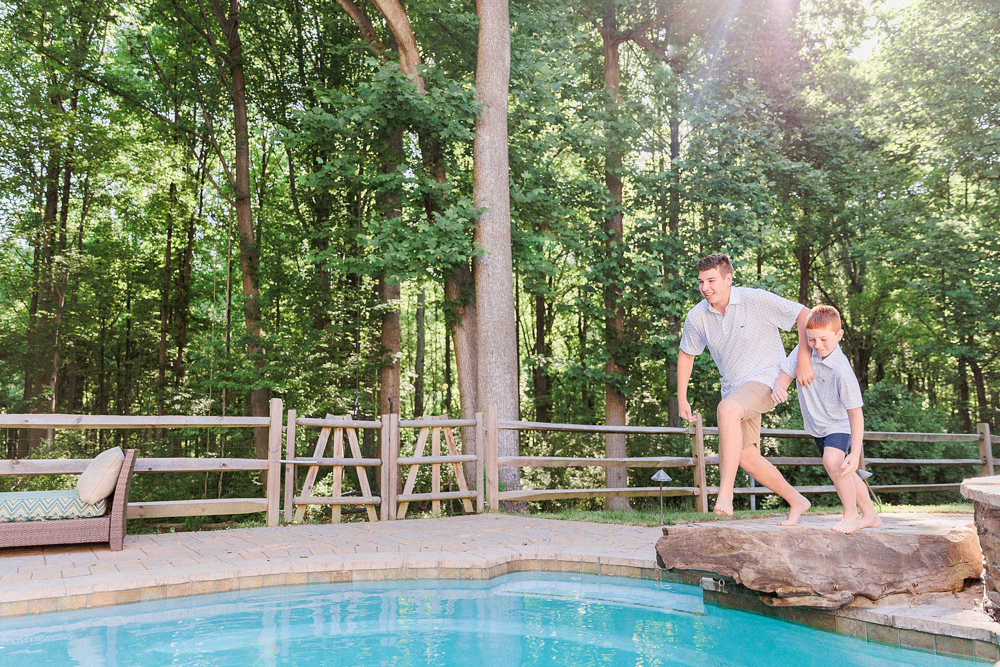 boys jump into pool during Maryland summer time photos 