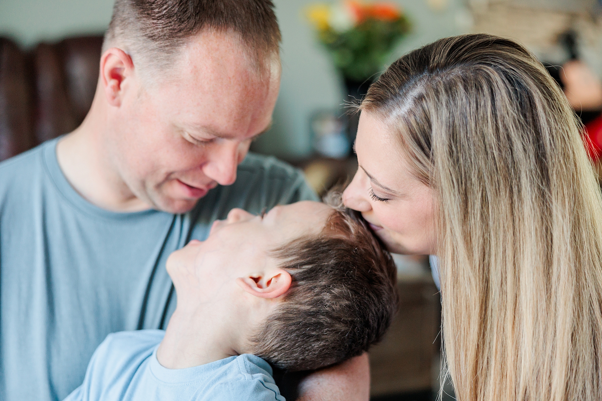 mom and dad hug son during family photos in Maryland 