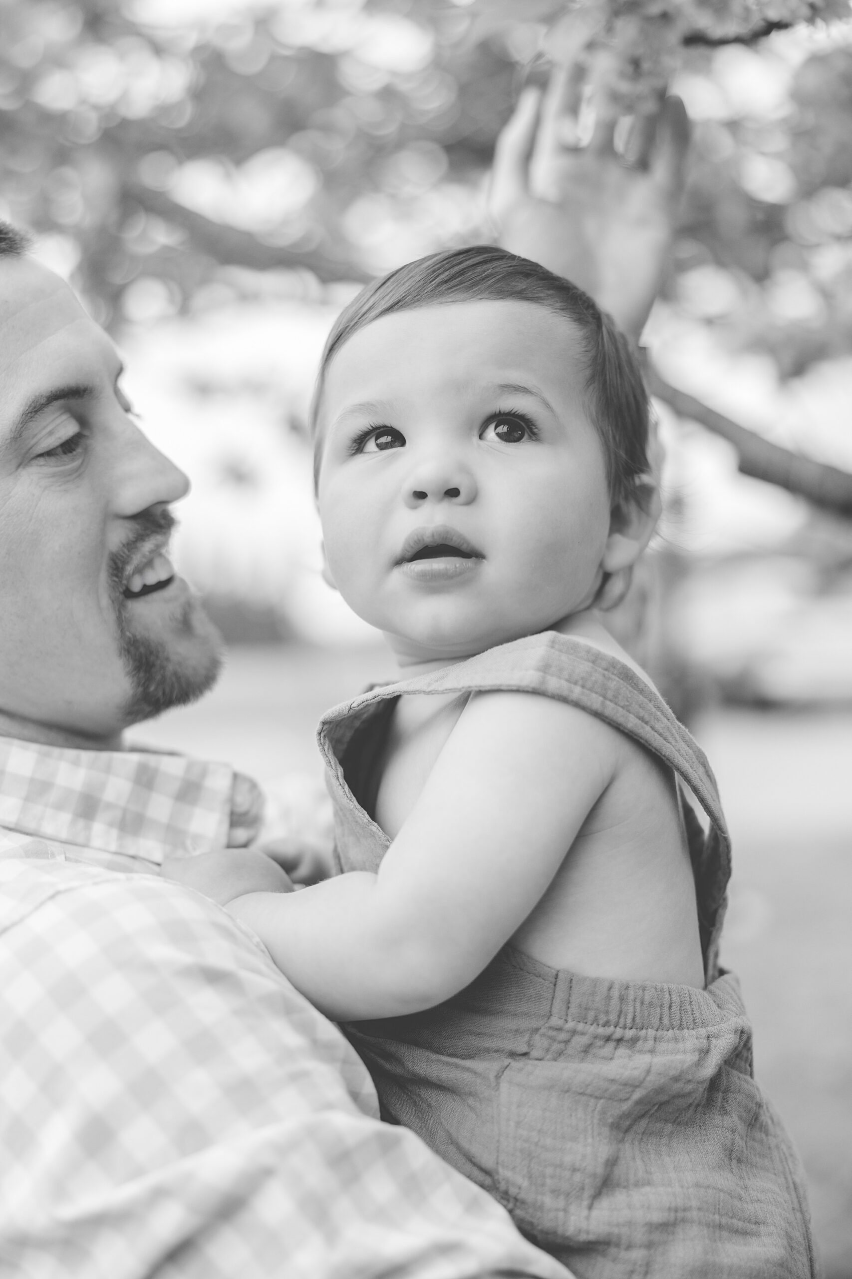 dad holds son up on his chest during Maryland Family Session in Ellicott City