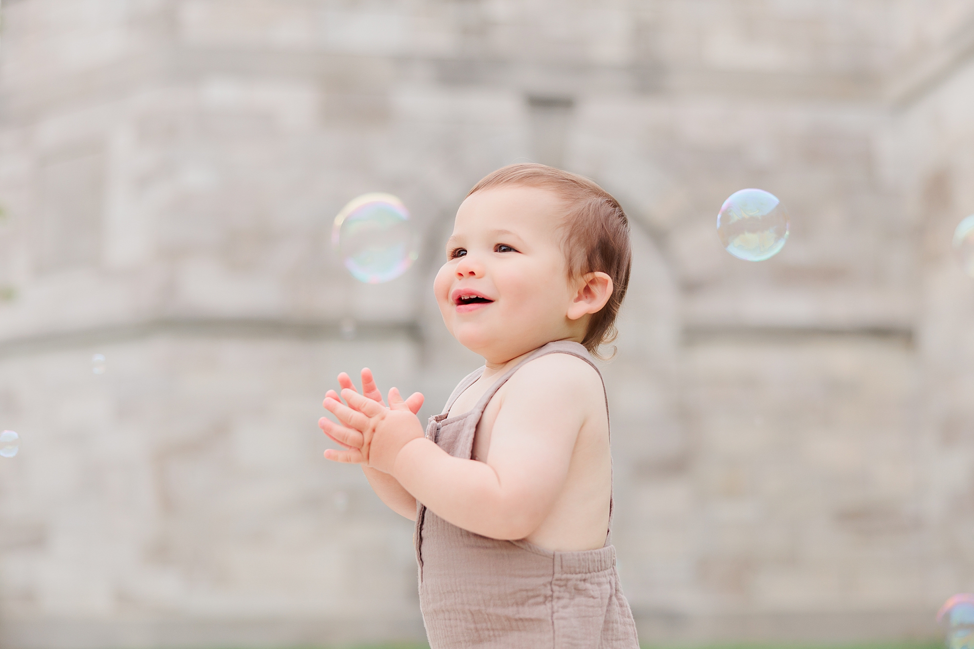 baby claps with bubbles around him during Maryland Family Session in Ellicott City 