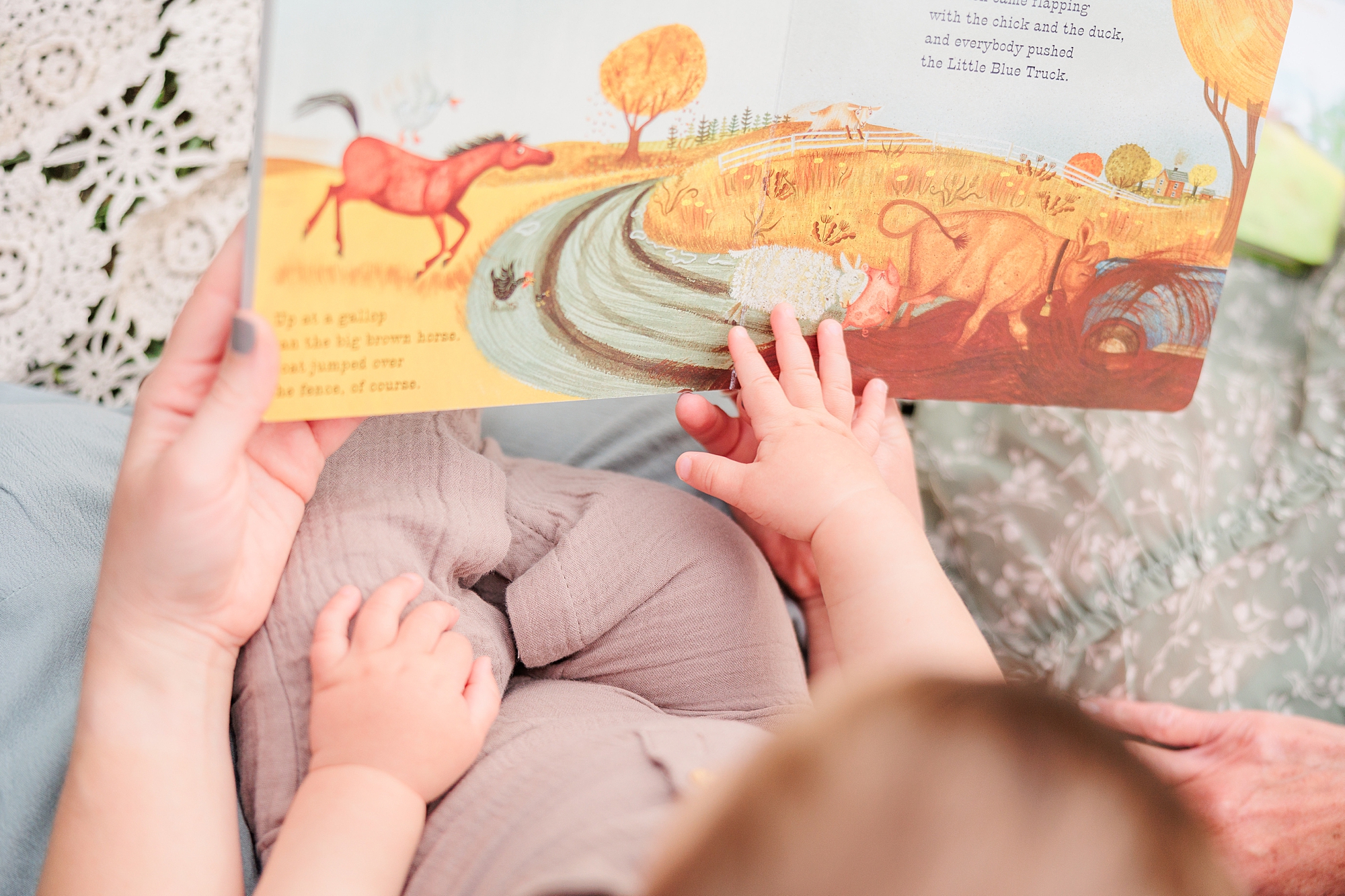 baby reads book during Maryland Family Session in Ellicott City 