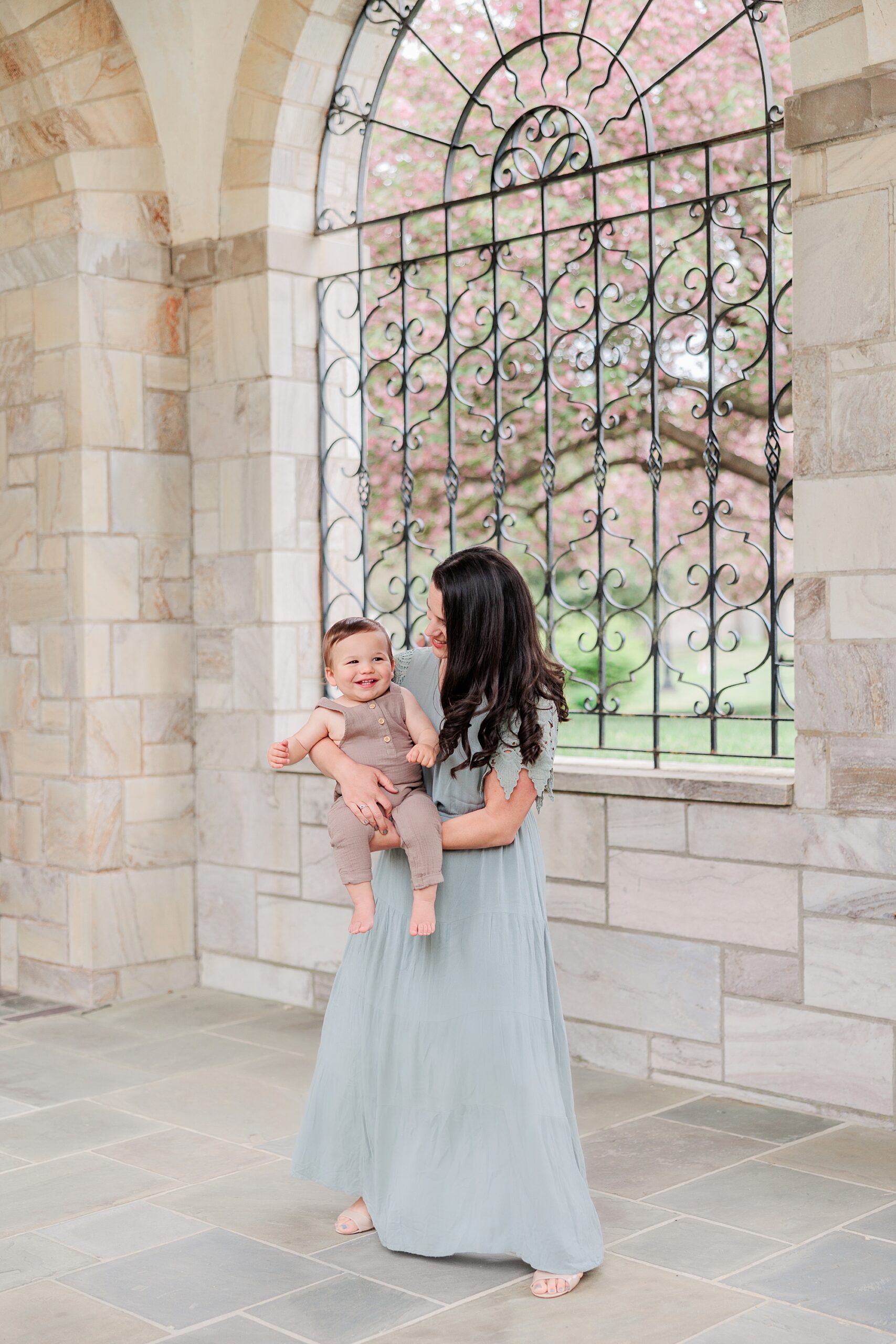 mom in blue dress holds son in front of her during Maryland Family Session in Ellicott City 