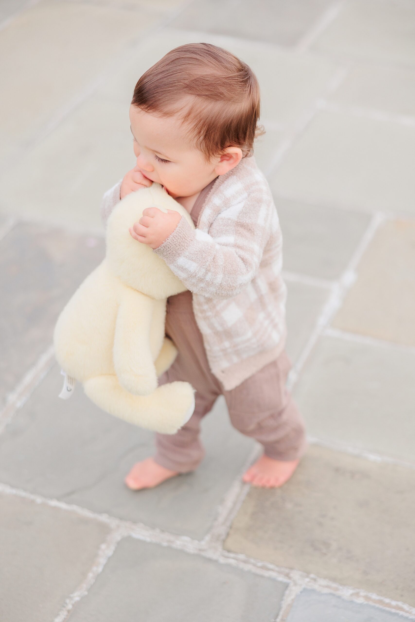 toddler walks chewing on stuffed animal in Maryland 