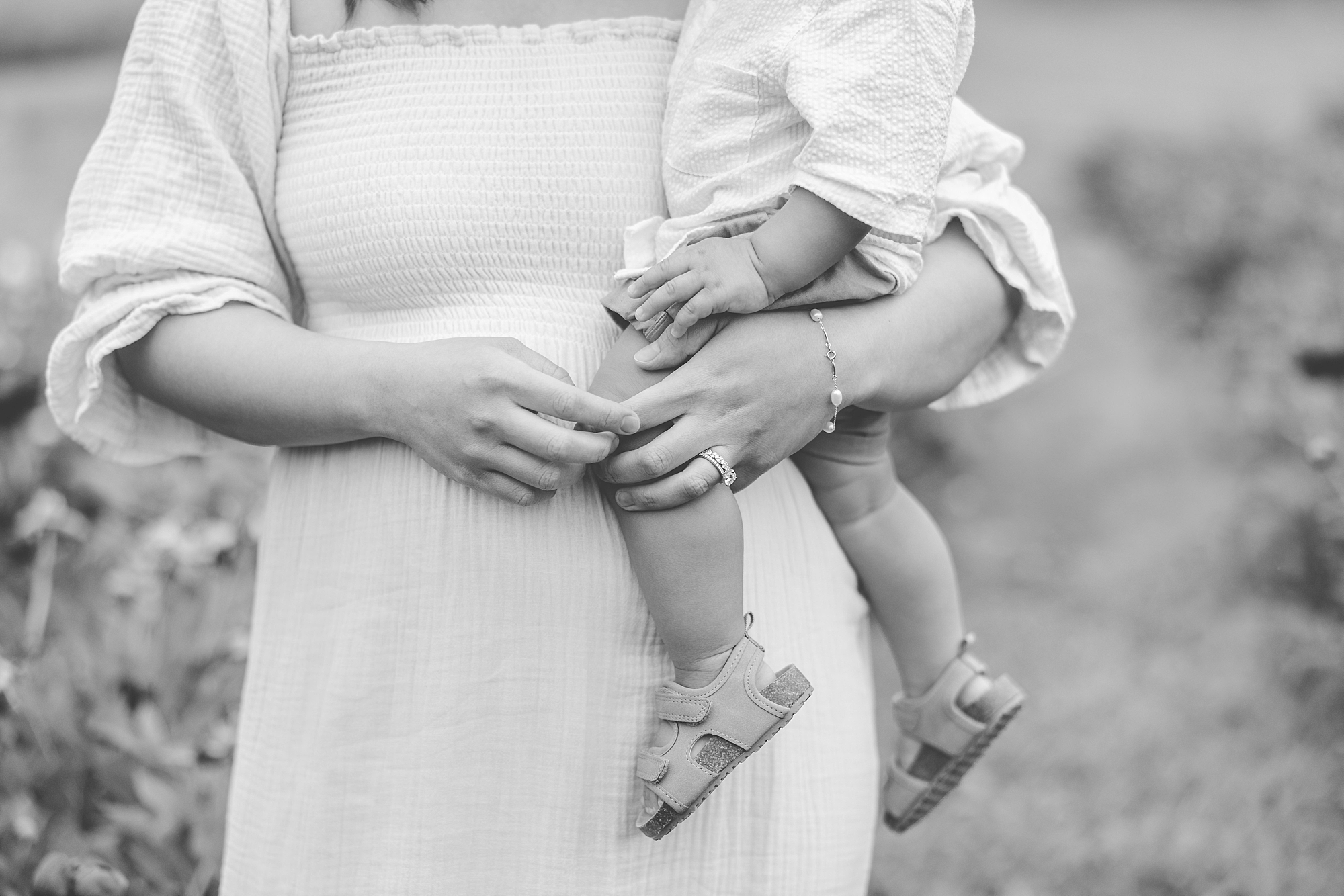 black and white photo of mom holding toddler on her hip