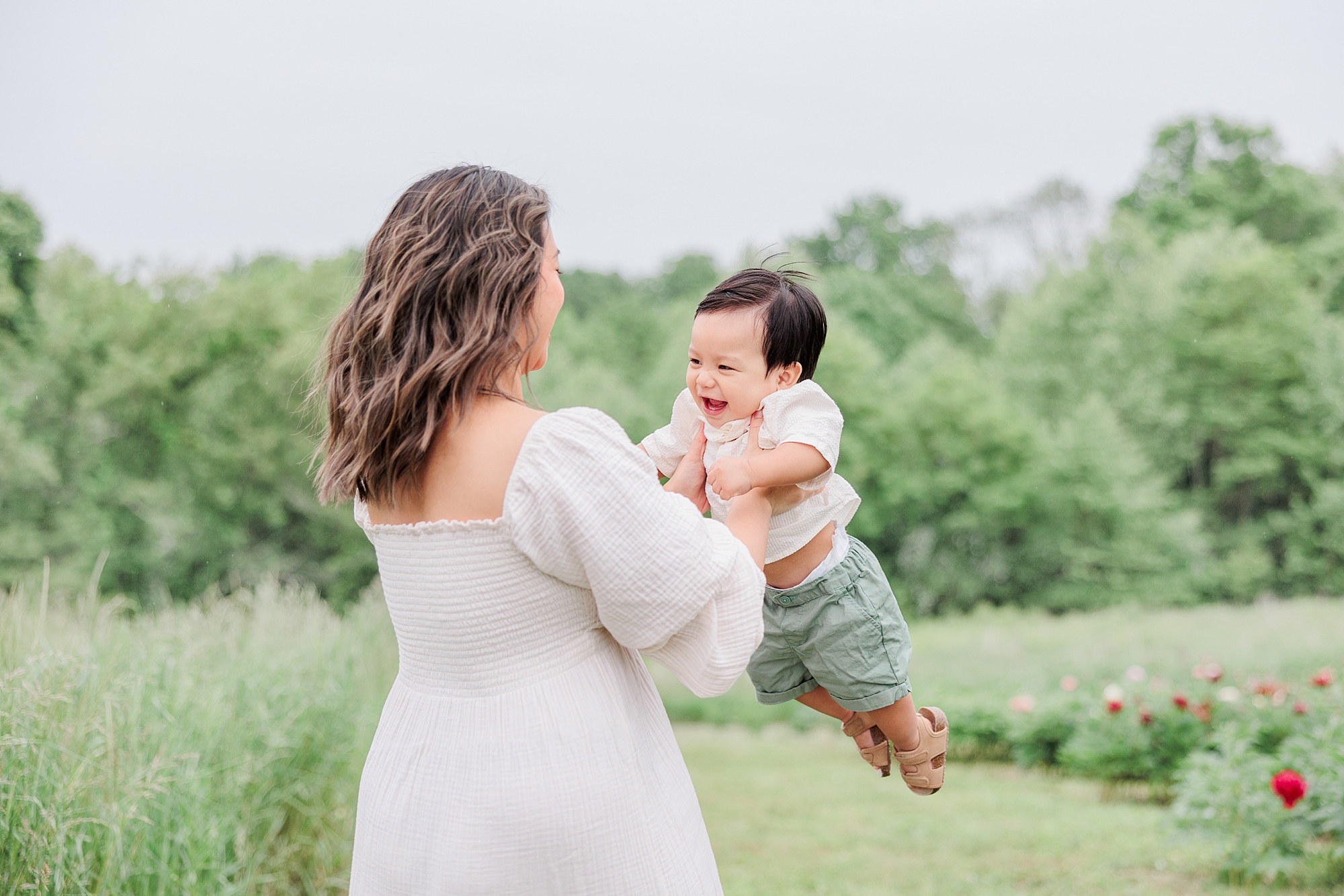 mom twirls around with toddler during family photos in Maryland 