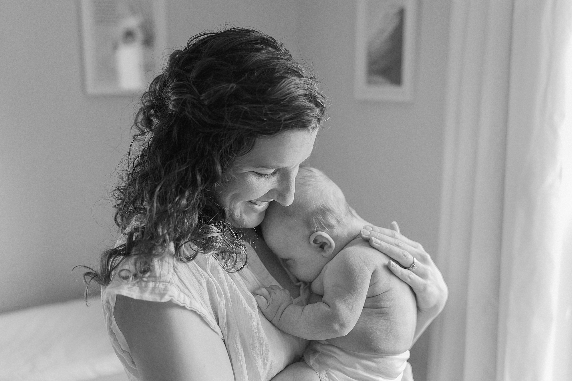 mom holds newborn son on her chest during lifestyle photos 