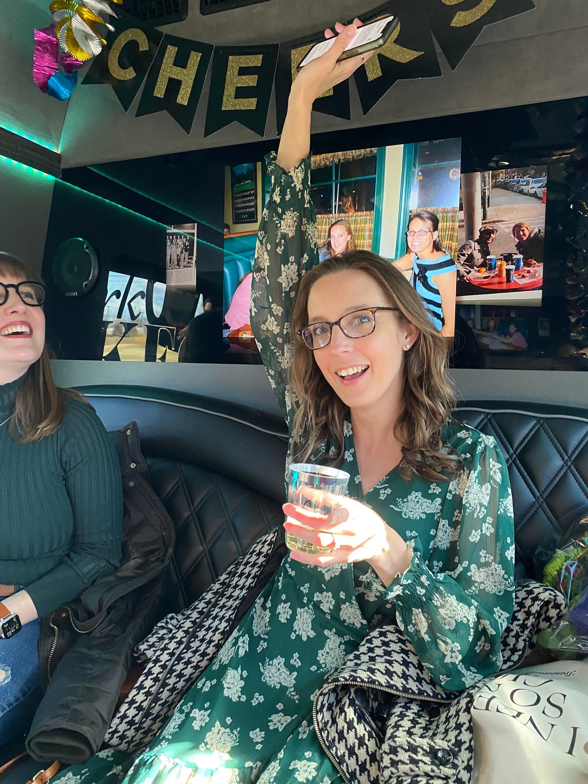 woman cheers holding drink in party bus