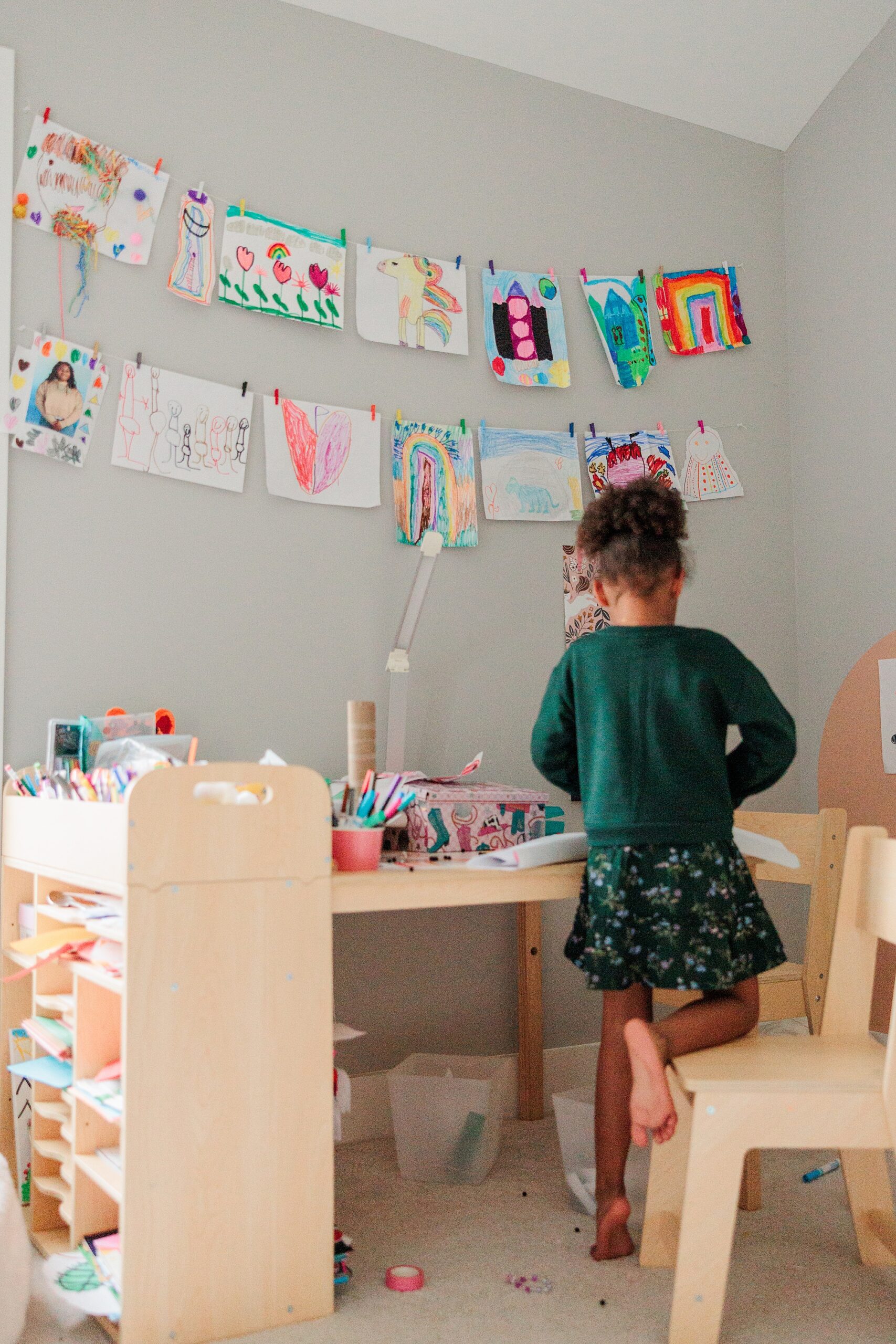 girl plays in bedroom during family photos in Washington DC