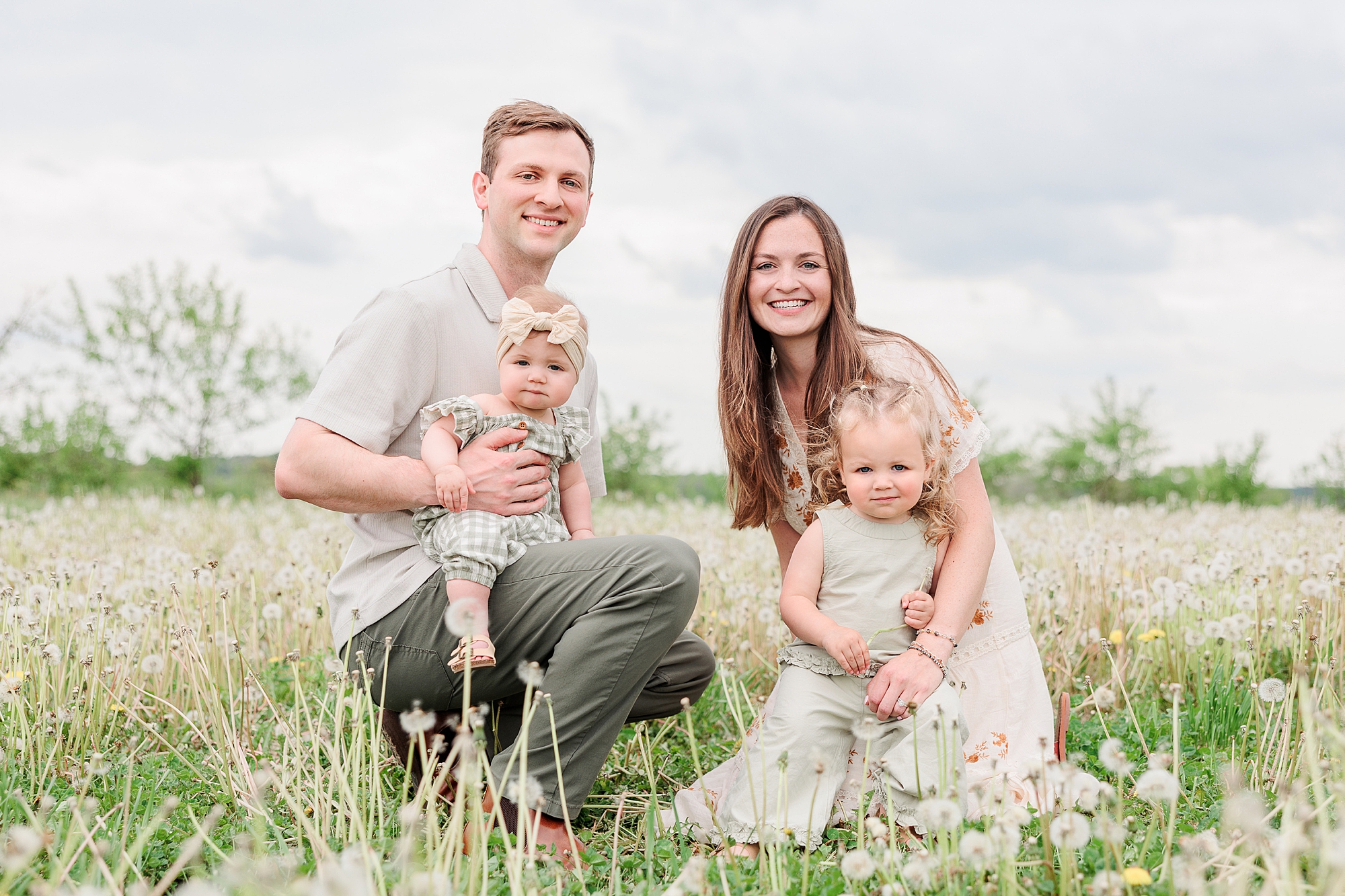 parents kneel with daughters on Baltimore farm 