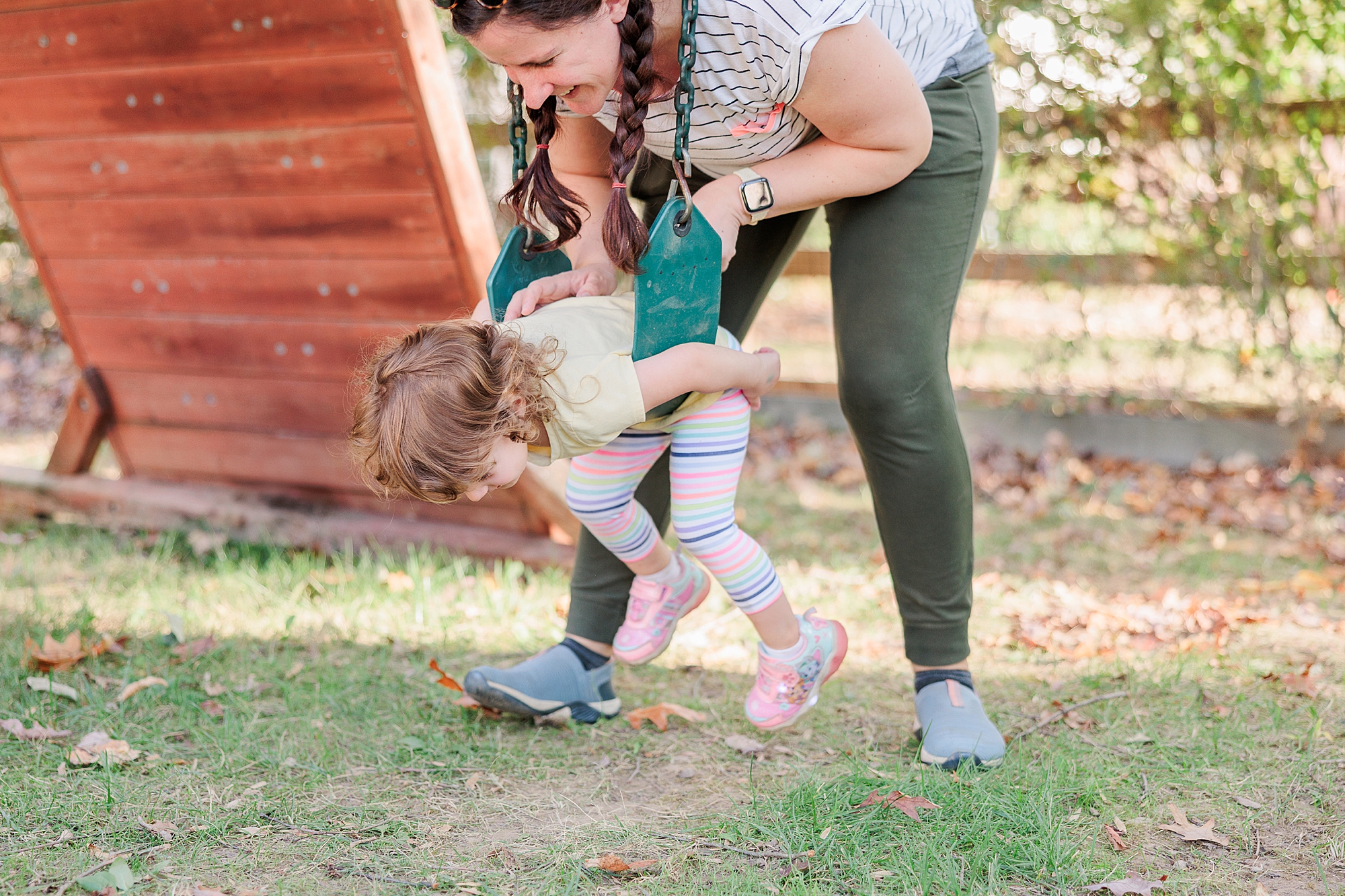 mom plays with daughter in backyard